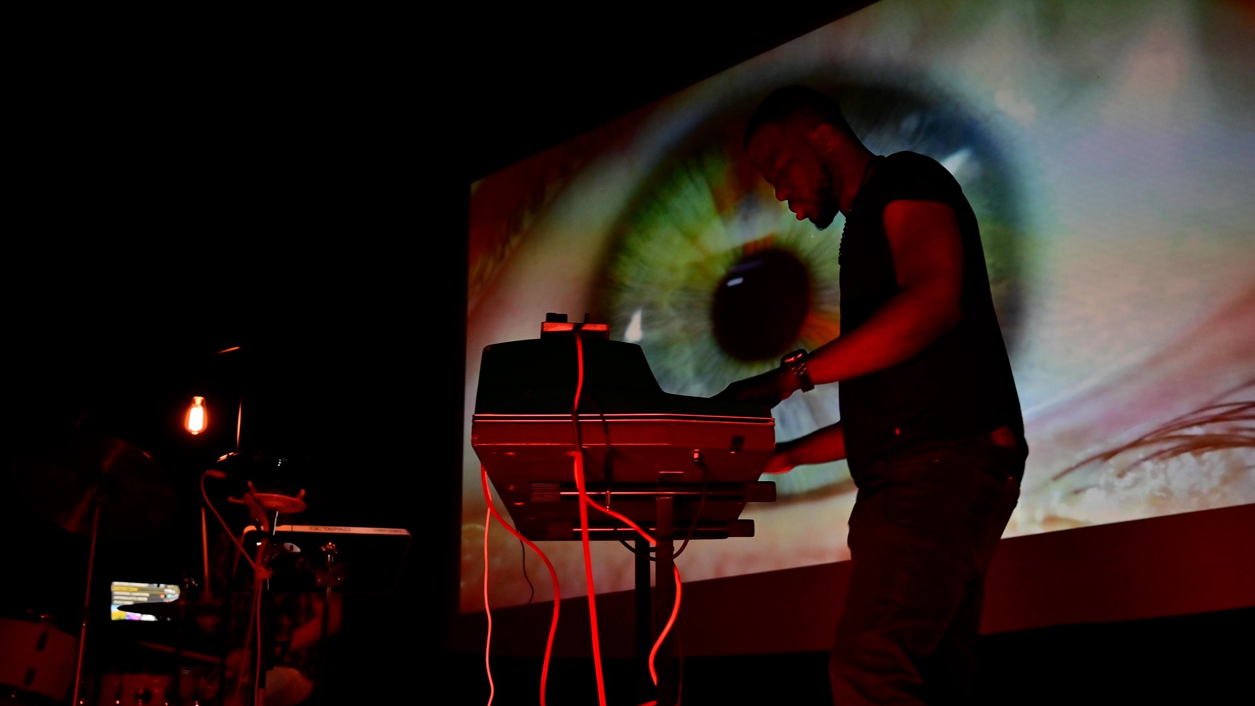 Keyboardist performing in front of Visibox visuals