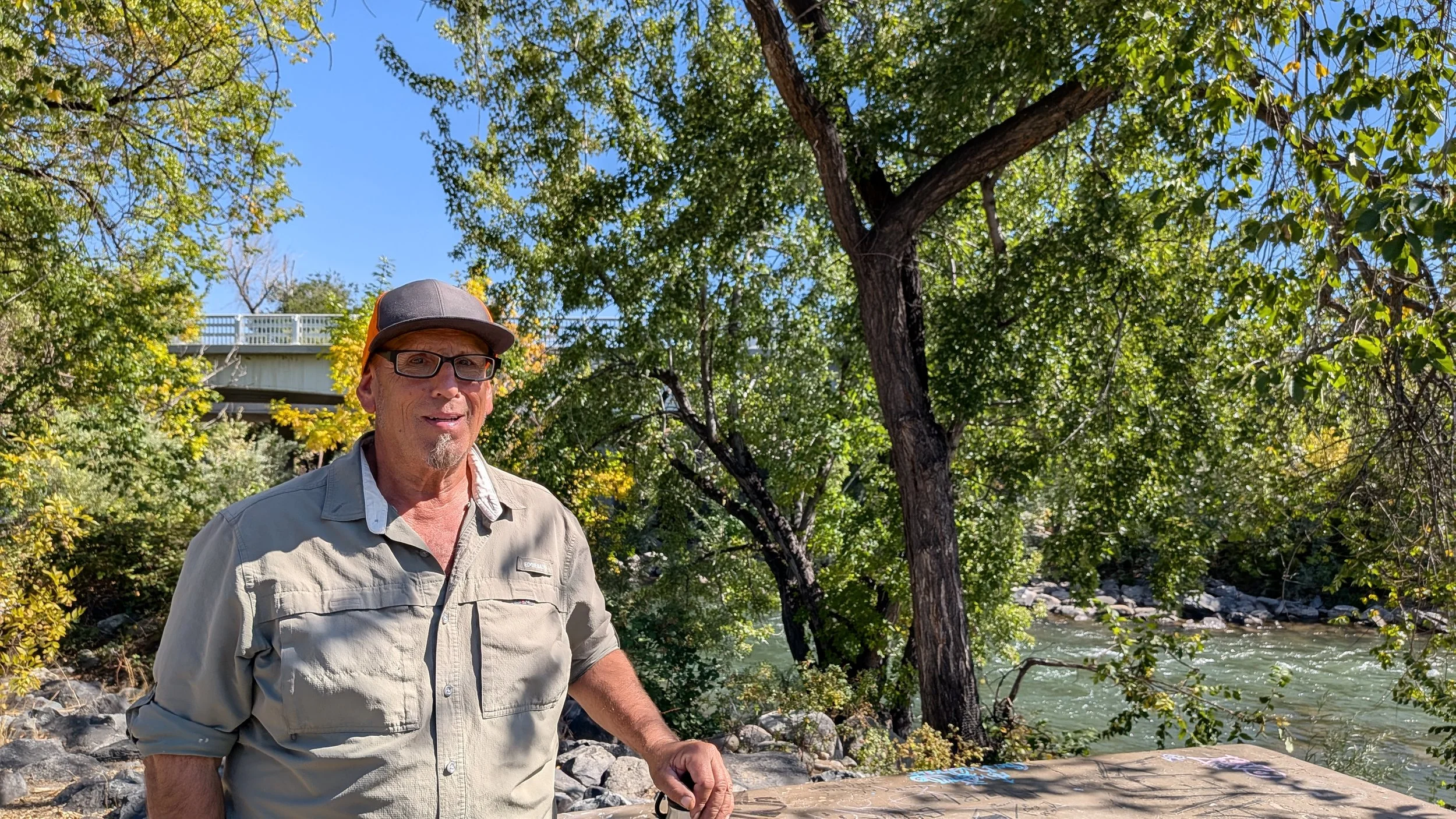 one truckee river workforce program crew member joe roybal standing in front of truckee river