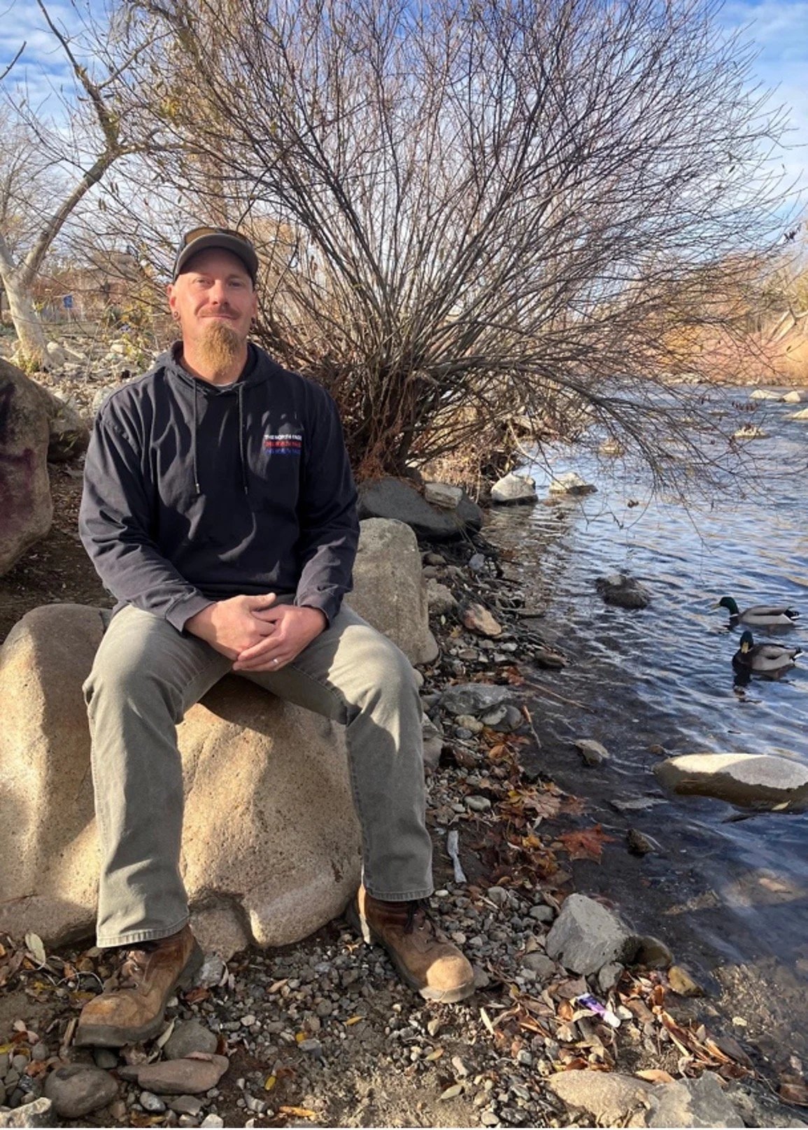 one truckee river workforce program crew member anthony reid with truckee river and tree in background