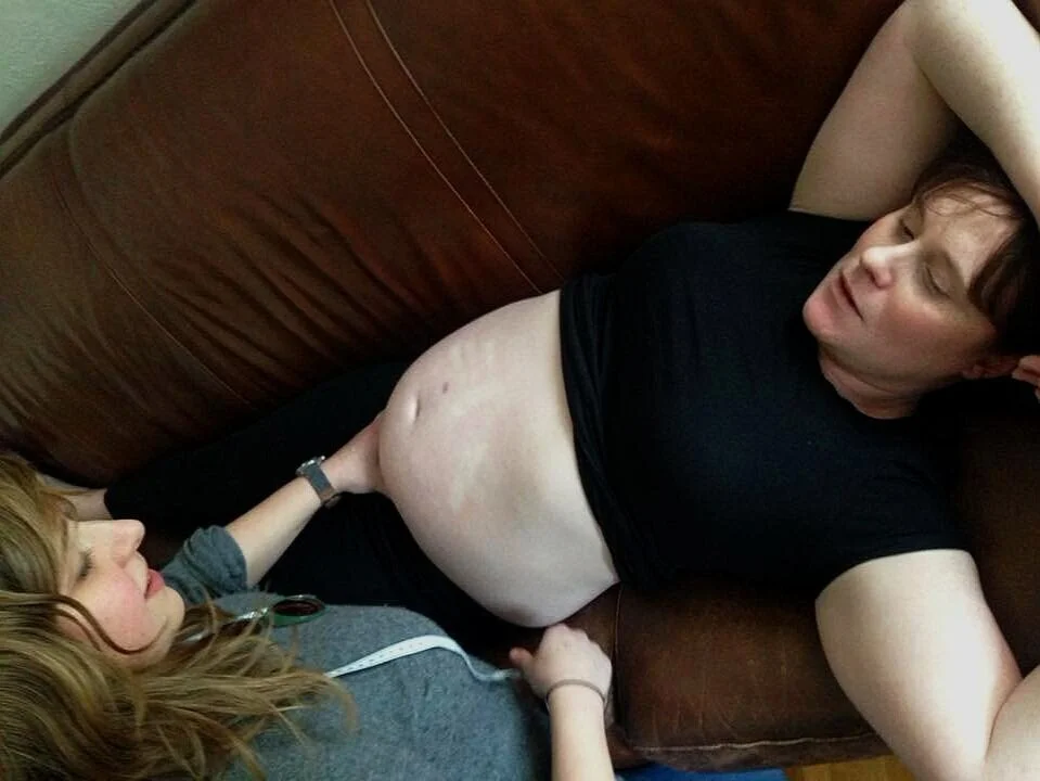 midwife palpating baby in prenatal checkup