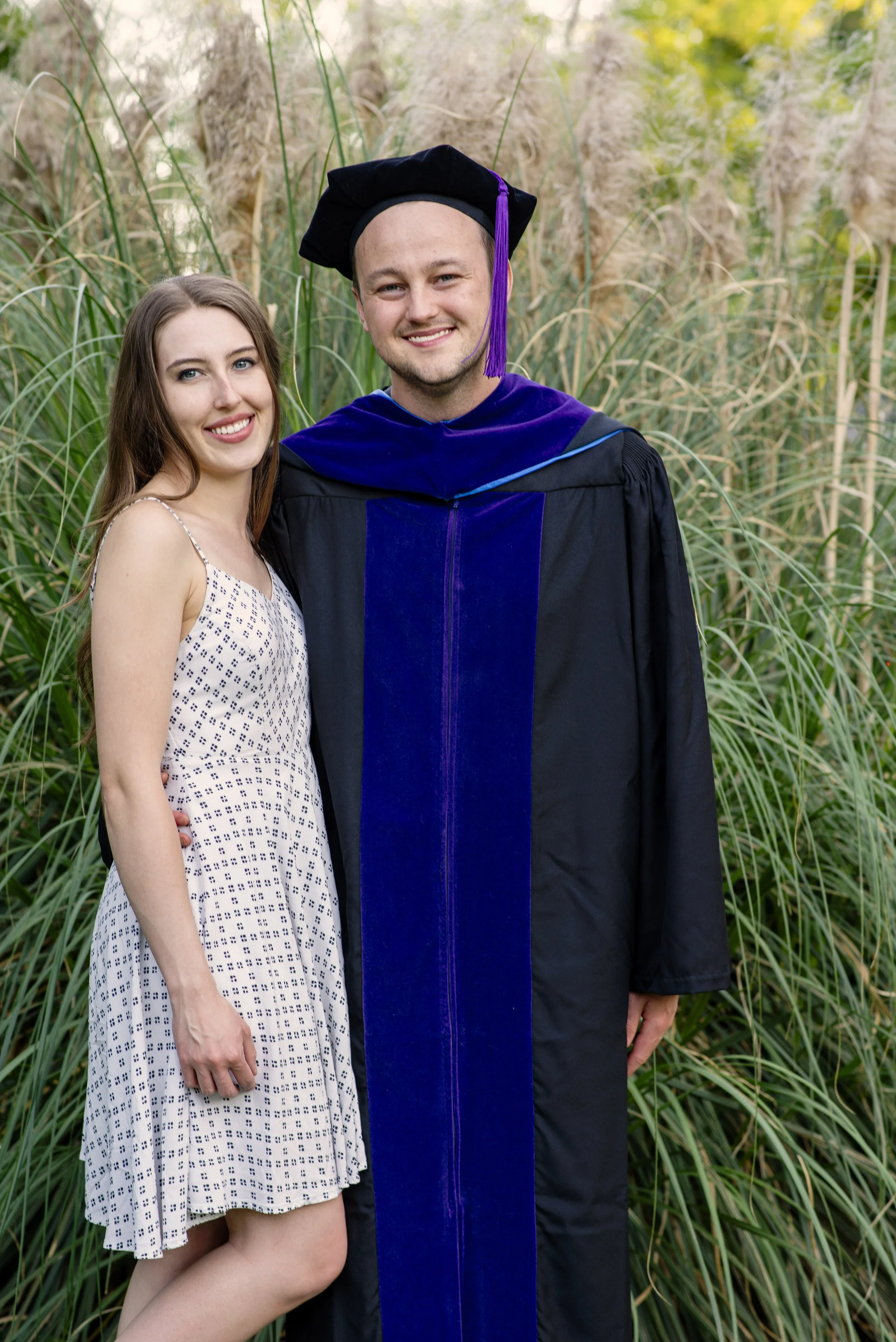 Graduate in cap and gown celebrating with a loved one