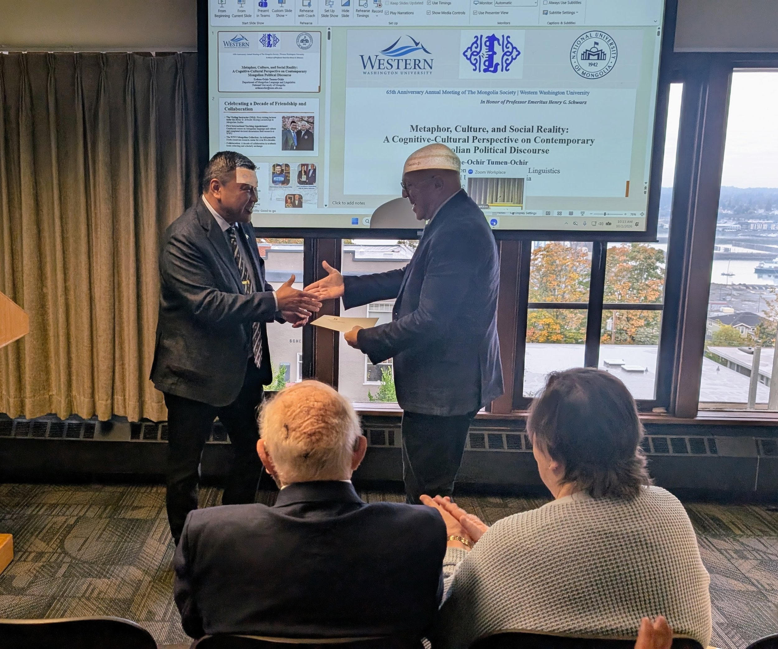His Excellency Ambassador Batbayar Ulziidelger presents a gift from the Embassy of Mongolia in the United States to President Michael Klecheski on behalf of The Mongolia Society.