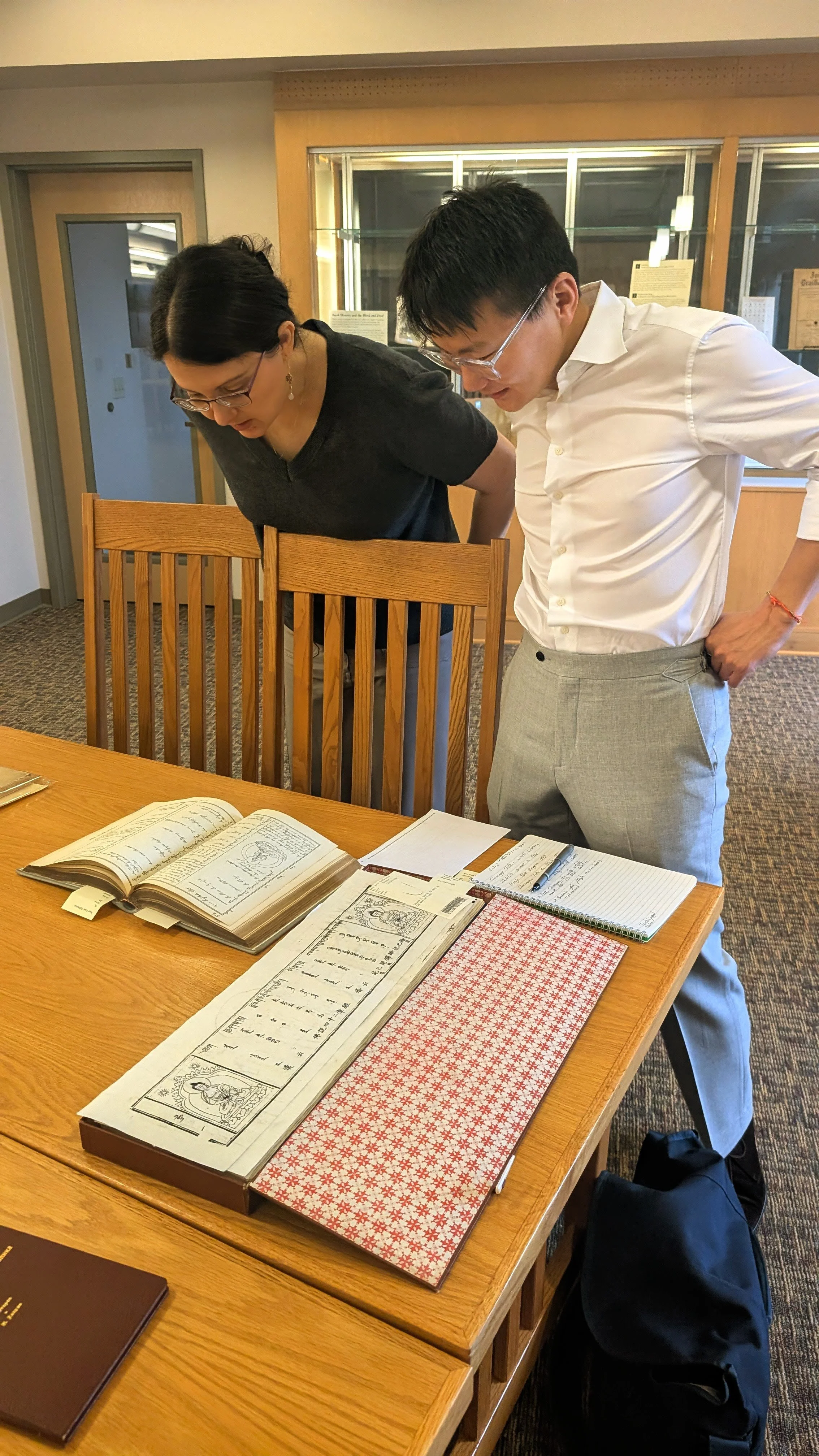 Prof. Charlotte D'Evelyn and Mr. Batorgil Batjargal examining selected texts.