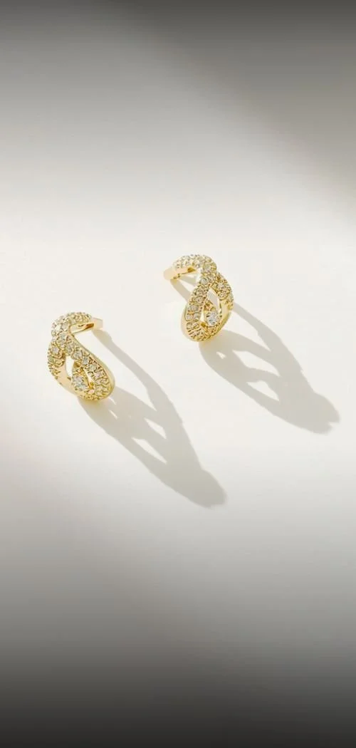 gold jewelry sparkling in the sunlight on a minimal background