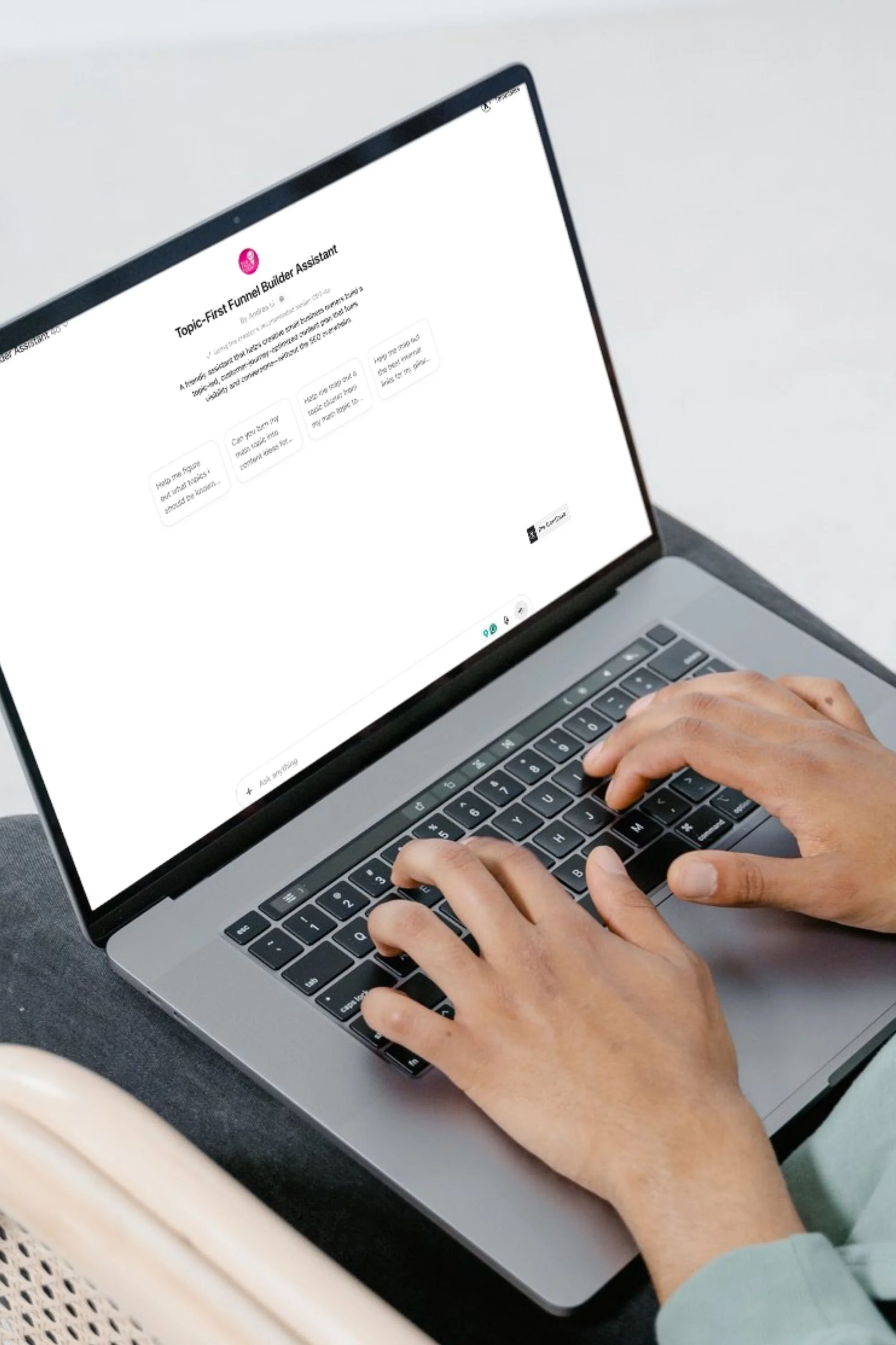 person using the Topic-First Funnel CustomGPT Assistant on a laptop