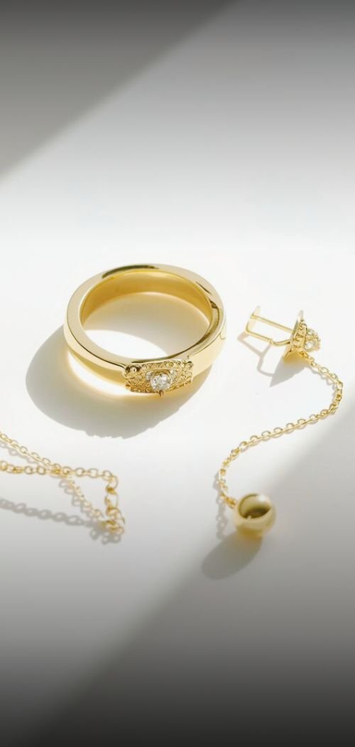 gold jewelry on a minimal background with a light beam.jpg