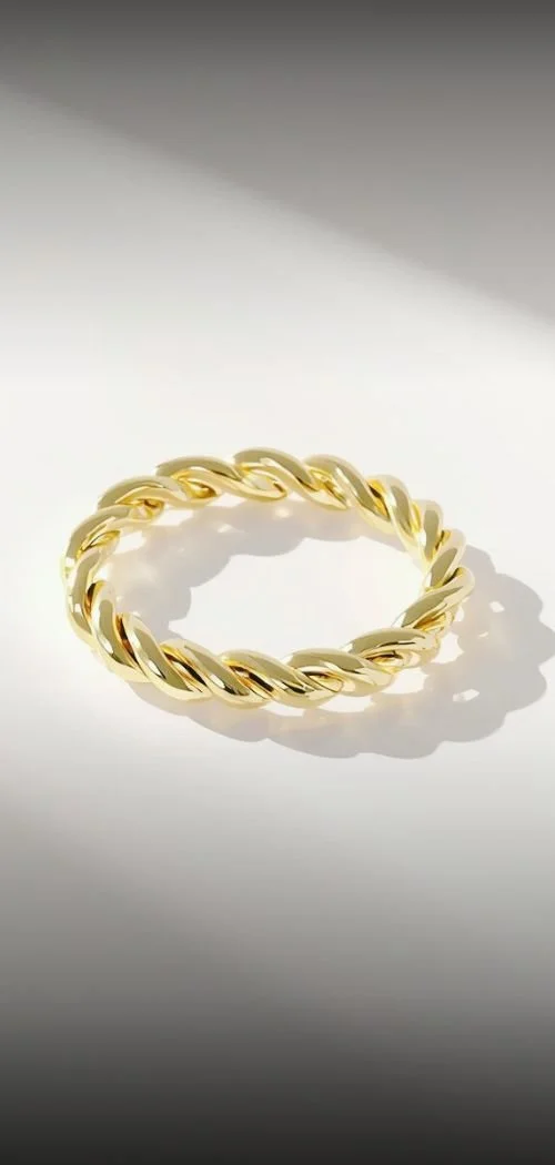 gold jewelry sparkling in the sunlight on a minimal background