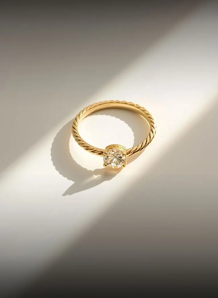 gold jewelry sparkling in the sunlight on a minimal background