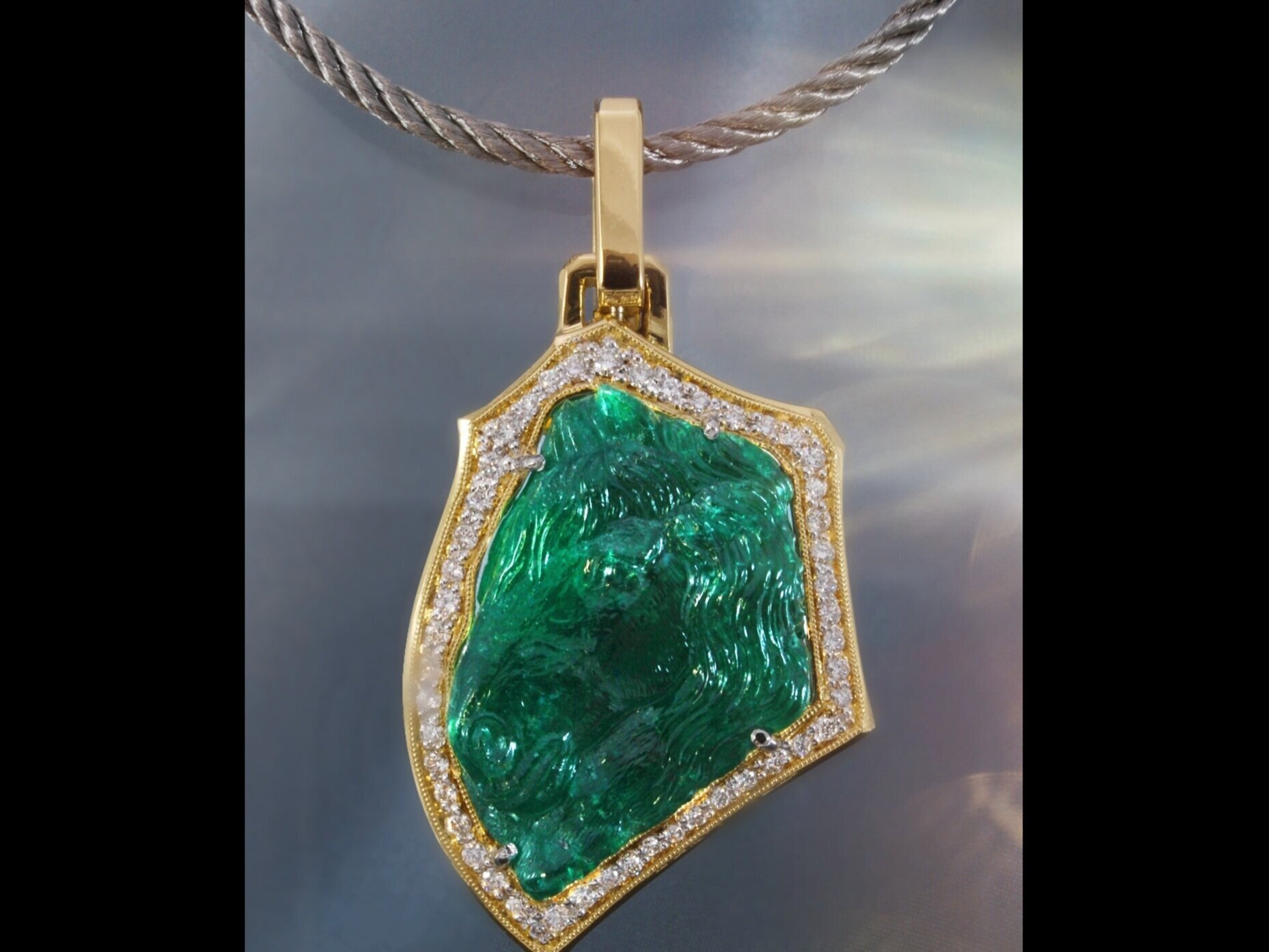Carved emerald pendant -gemsandcarvings.com