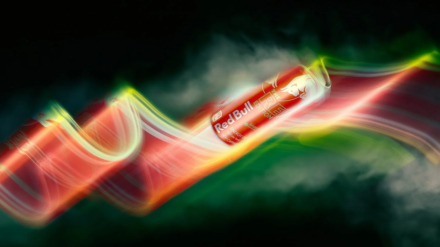 A vibrant, motion-blurred image of a Red Bull can with colorful light trails against a dark background.
