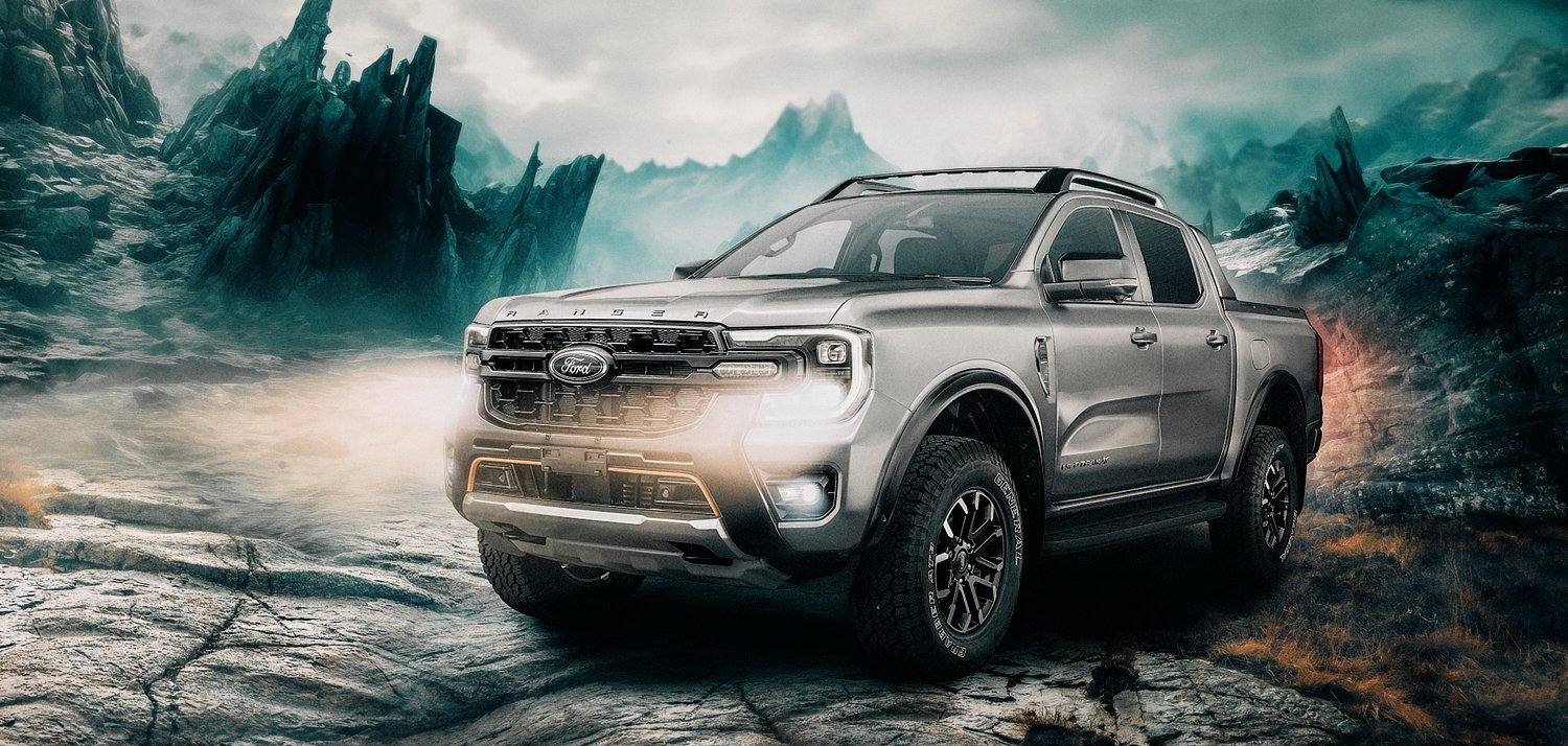 Silver Ford Ranger pickup truck in a rugged mountainous landscape with dramatic lighting.