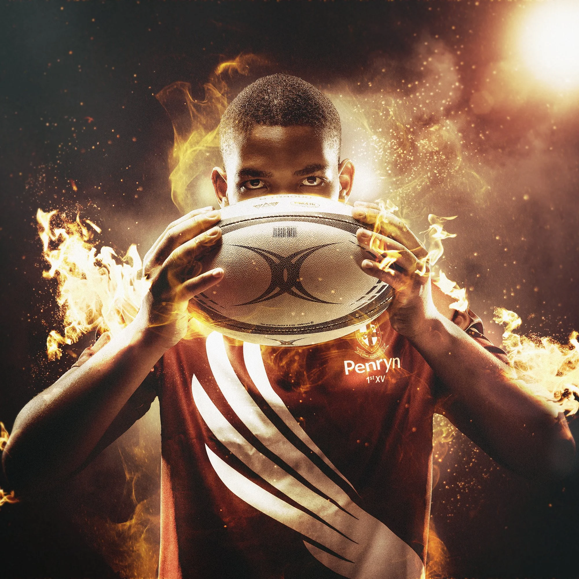 A person in a sports jersey holding a rugby ball with flames surrounding it, creating a dramatic effect.