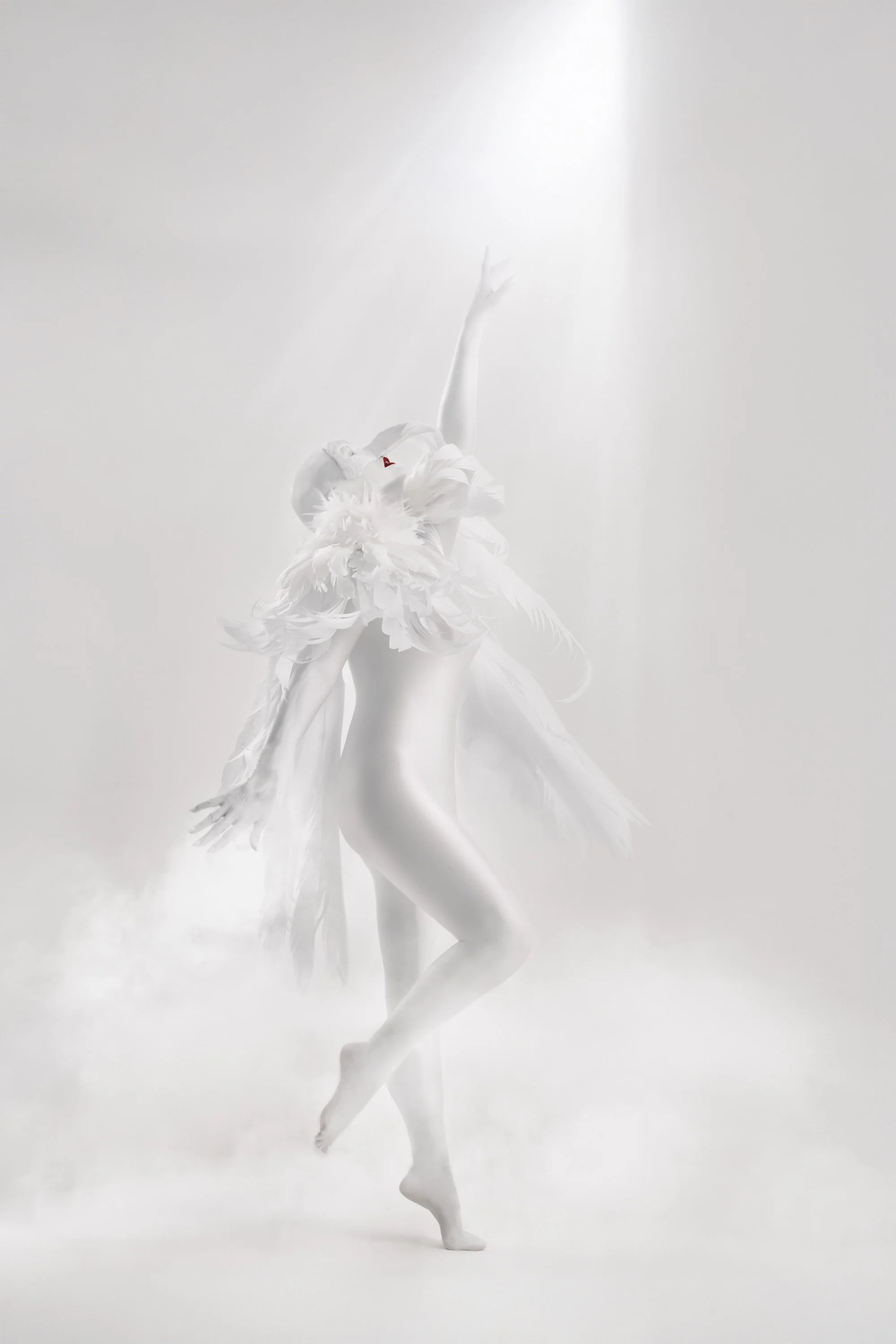 A woman with an elaborate white feathered outfit, striking a pose, with one arm raised and standing on one leg, in a bright, foggy setting. She is a representation of a Harpy from Greek mythology. 