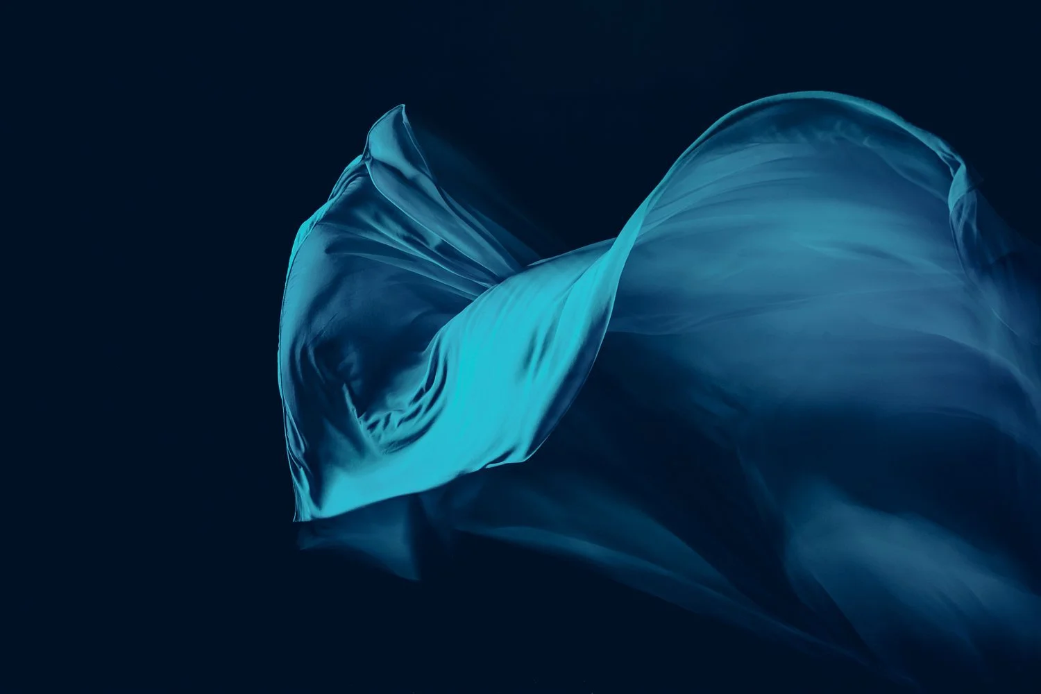 Flowing blue fabric against dark background