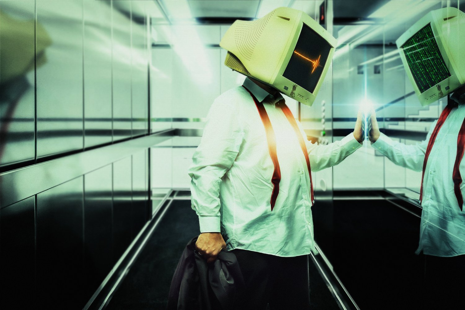 Person with computer monitor head touching a mirror in an elevator.