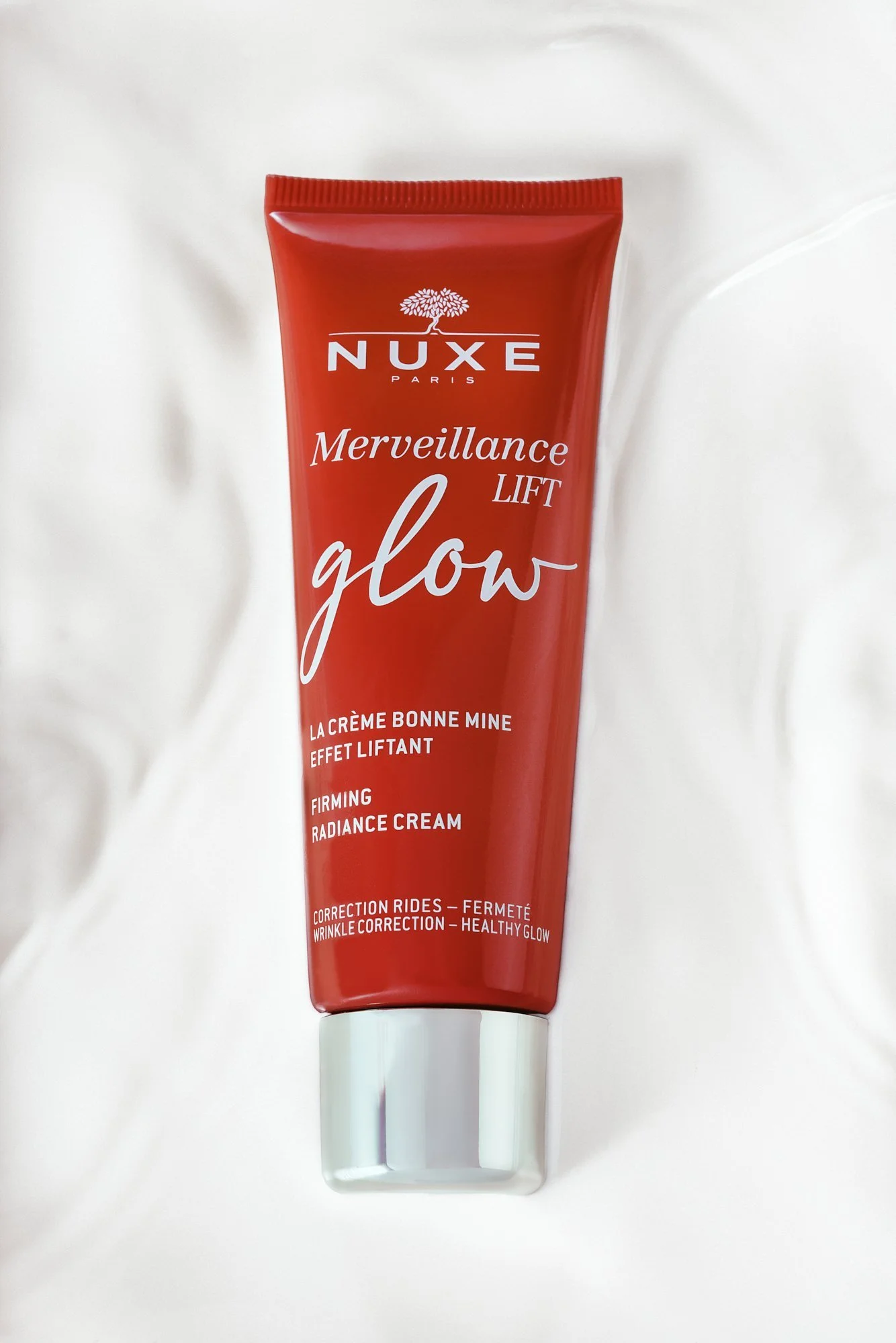 Nuxe Merveillance Lift Glow Firming Radiance Cream tube on a white background.