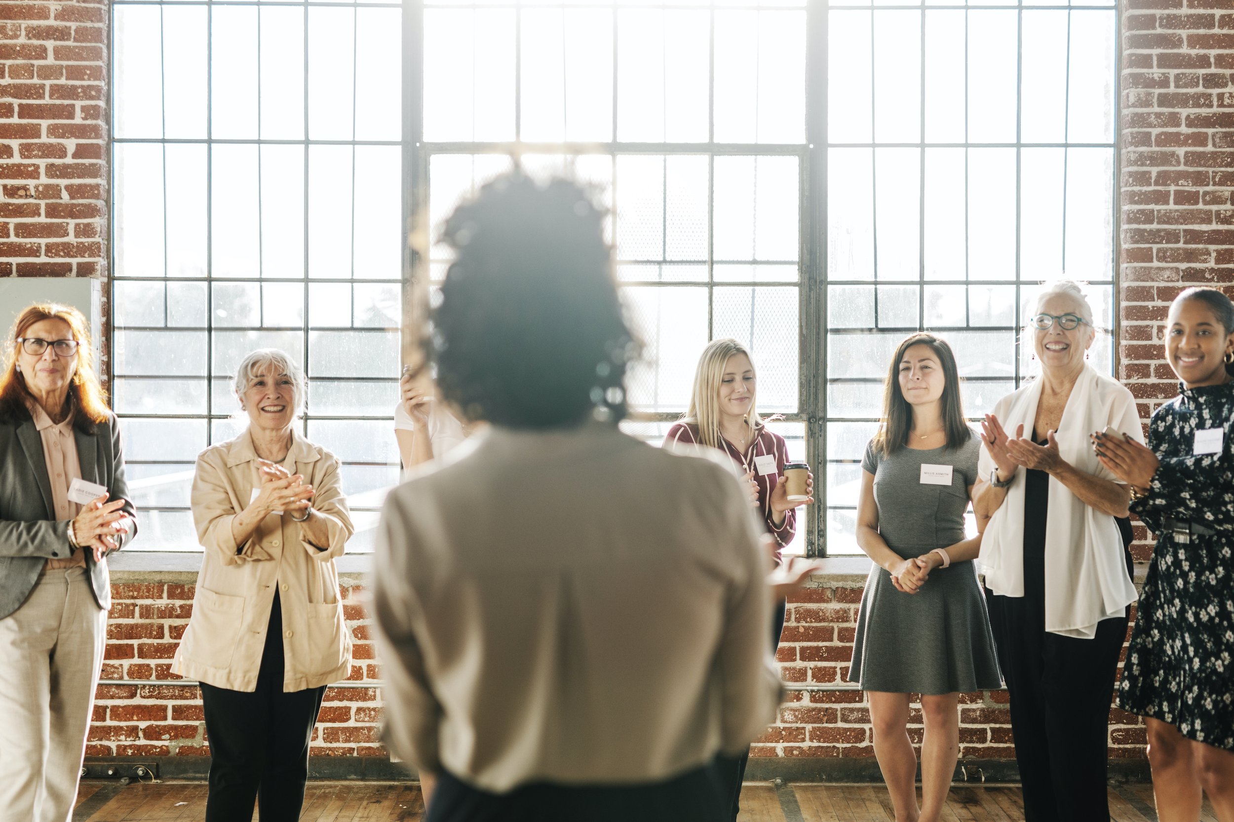 woman presenting at a small conference