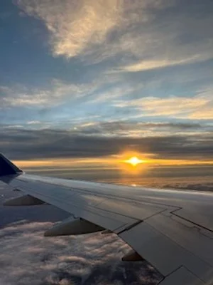 sun over the wing of the plane.jpeg
