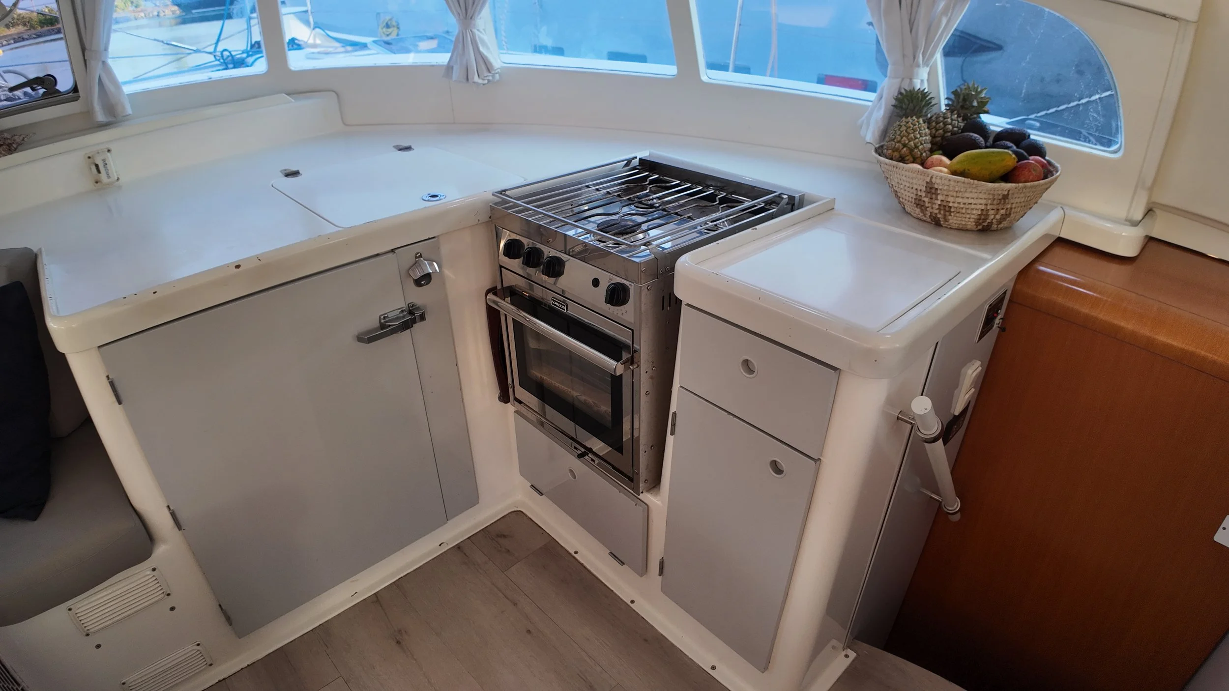 Galley with Force 10 stove and oven and hard-surface countertops.