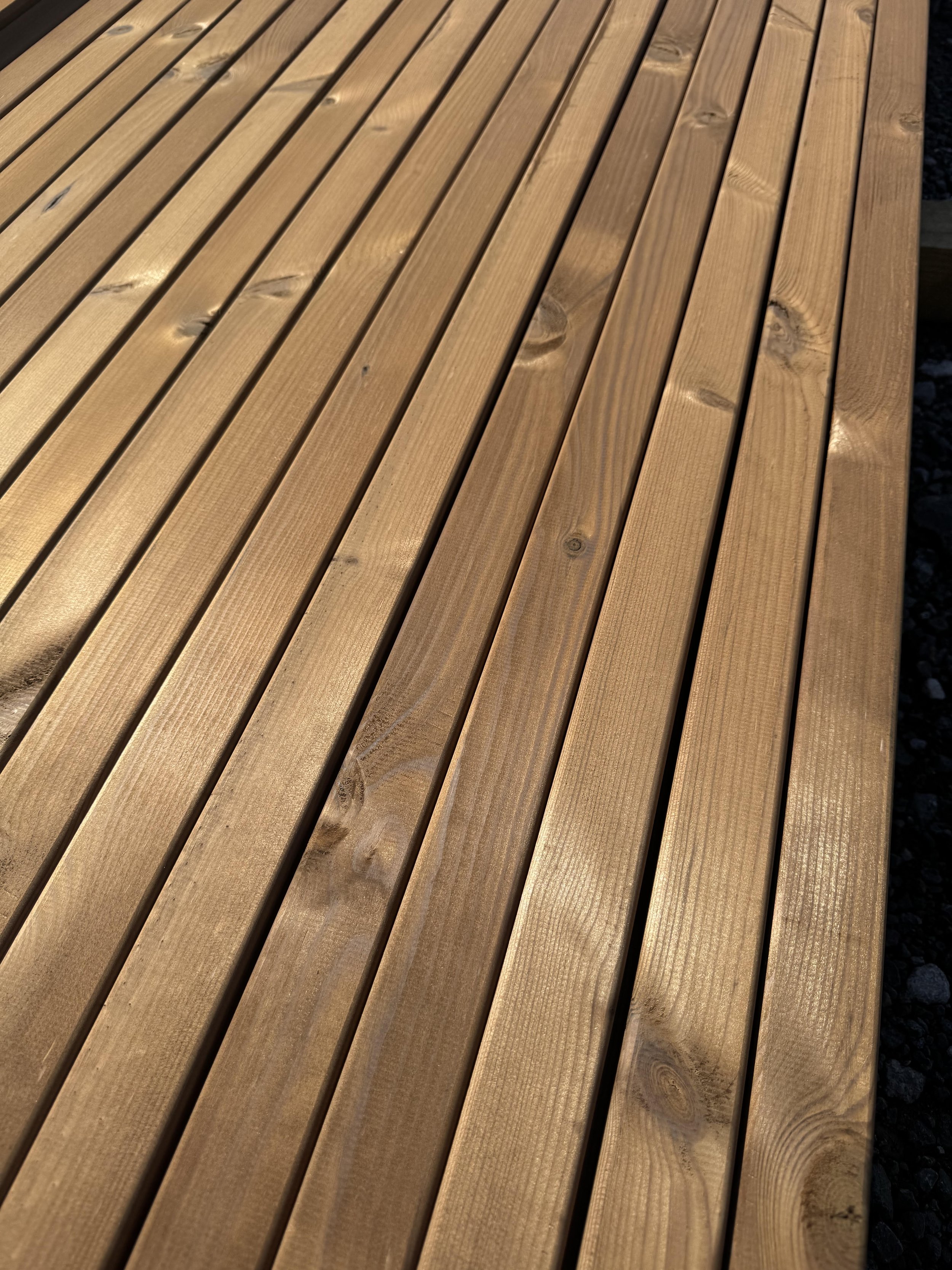 Thermo Timber Fencing battens in a bundle on a yard surface