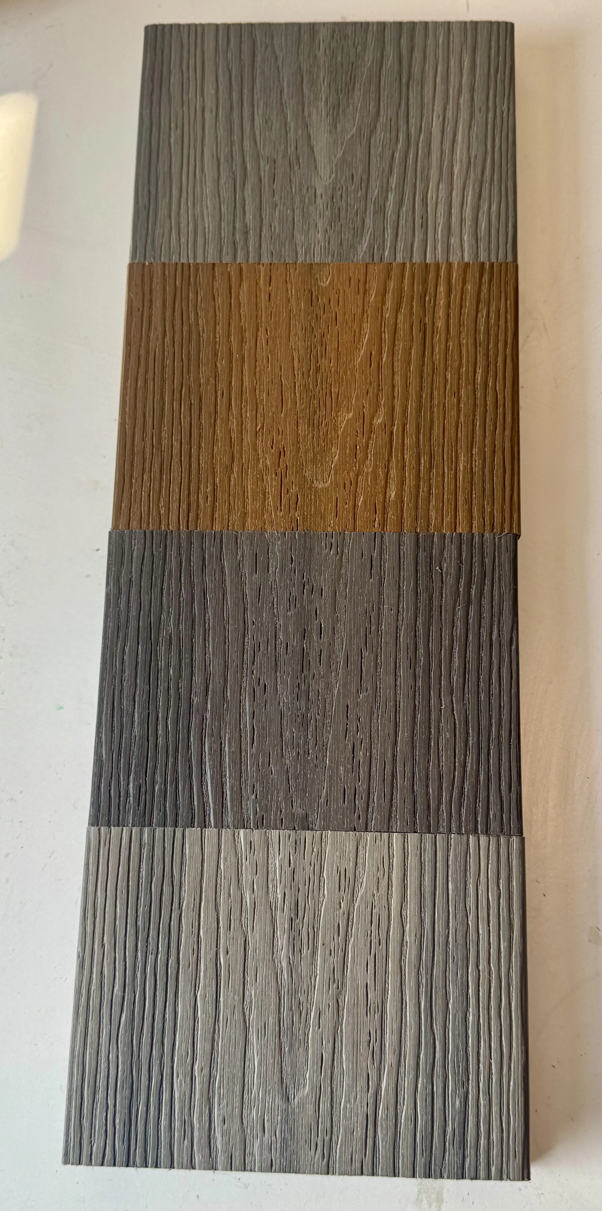 A display of sample of the Essentials Range composite deck boards by Newtech wood