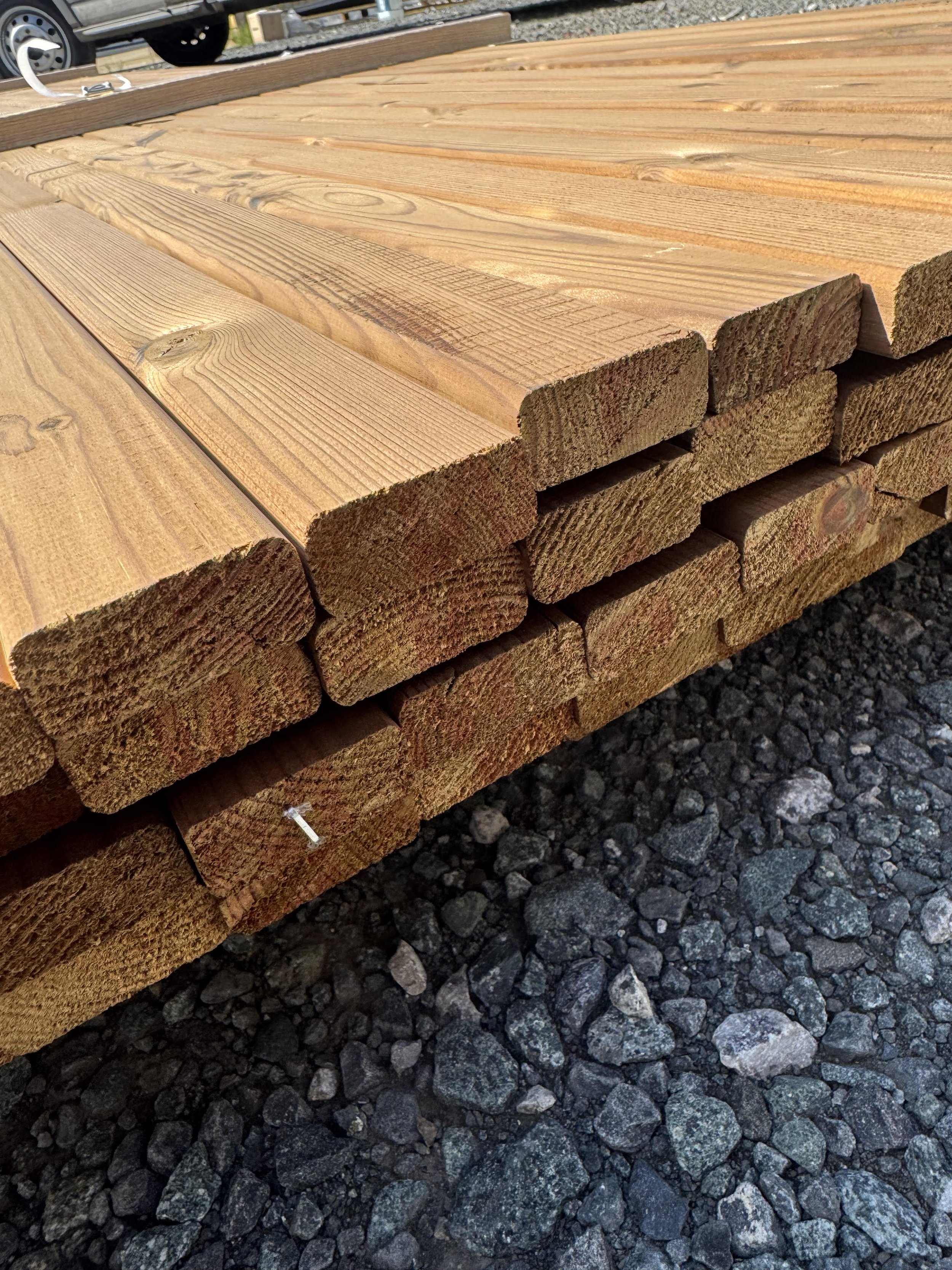 Thermo Timber Fencing battens in a bundle on a yard surface