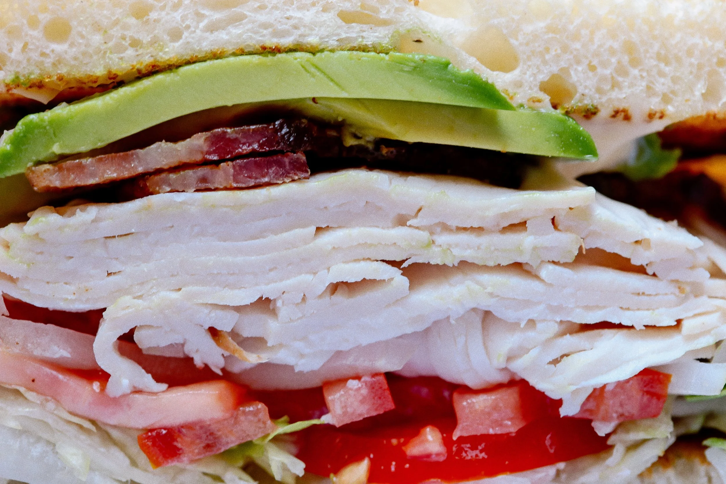 Up close &amp; personal with our best-selling overstuffed sandwich 🌱🍅🥑🥬