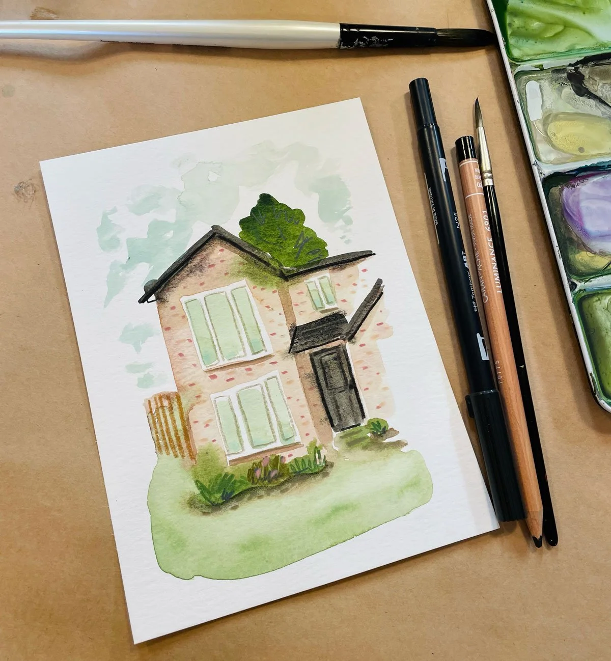 A small mixed media painting of a house we stayed at as a thank you gift for opening their home to us