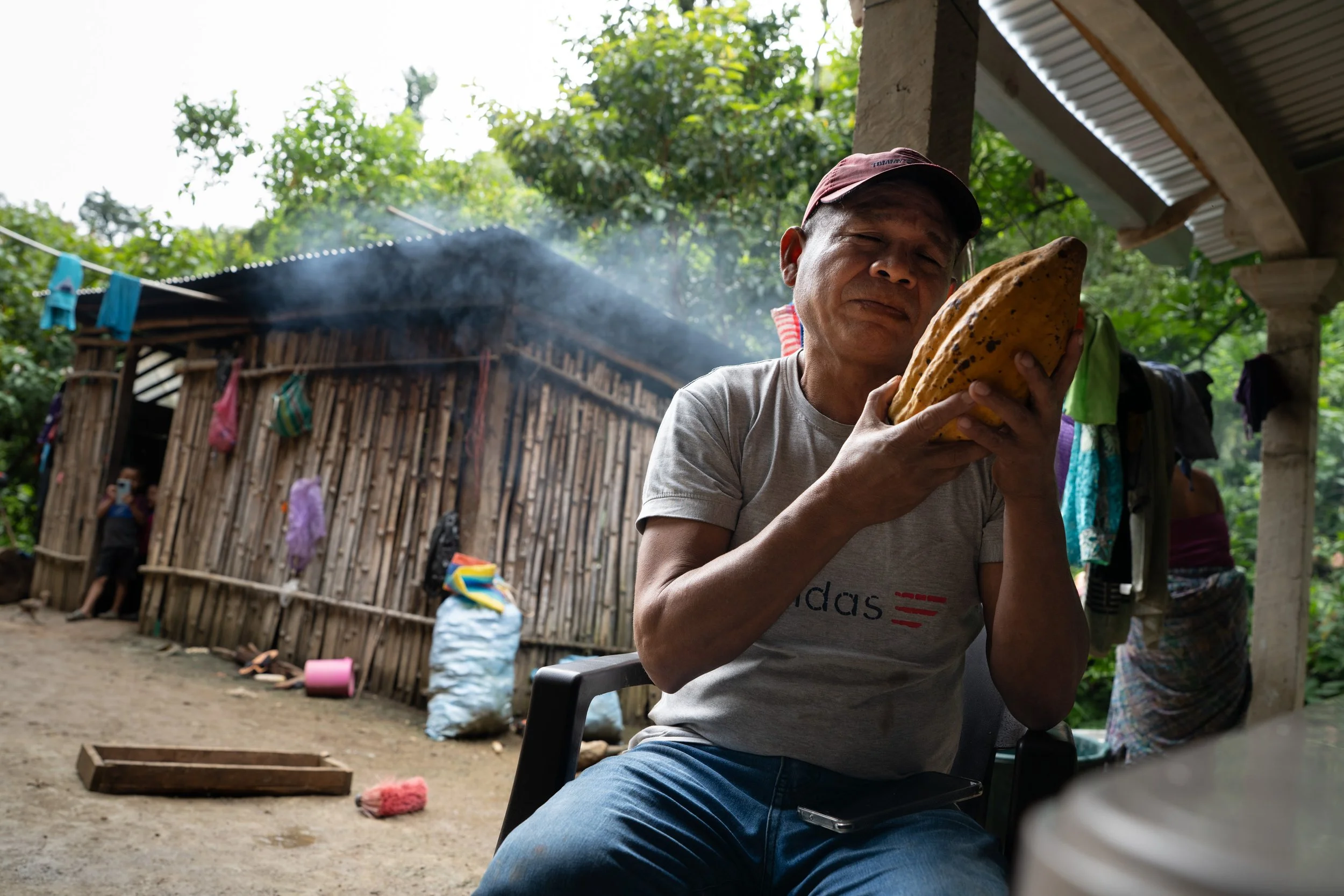 Lauro Cahal with a beloved Crillollo cacao pod at his farm near Lanquín, Guatemala. He expresses deep gratitude for cacao, which he says makes everything in his life possible.