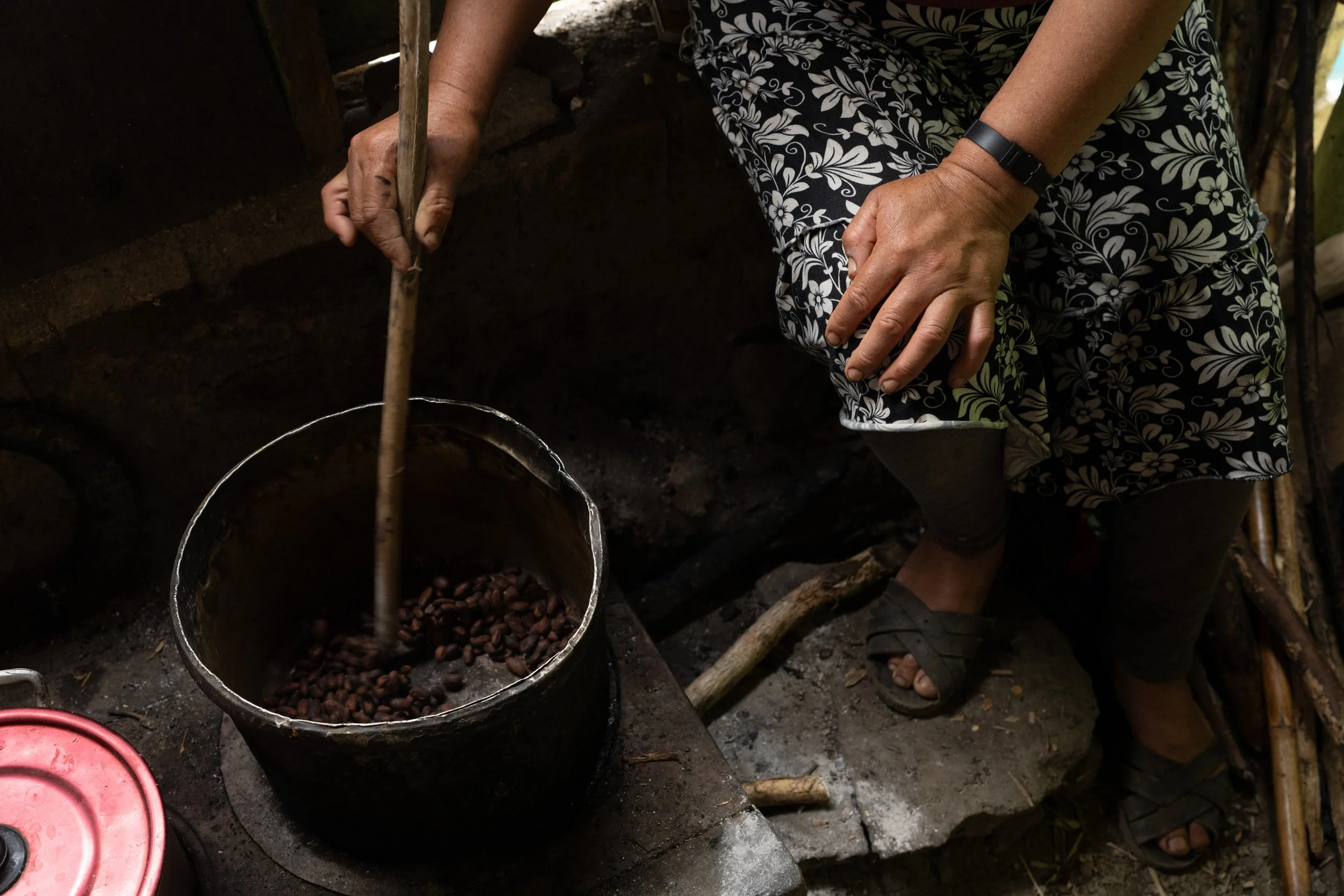 Mirtha Huaman Garay roasts cacao beans which she will peel and grind into a paste to make sipping chocolate. Few rural cacao growers have tasted chocolate in the bar form that is popular in industrialized countries.