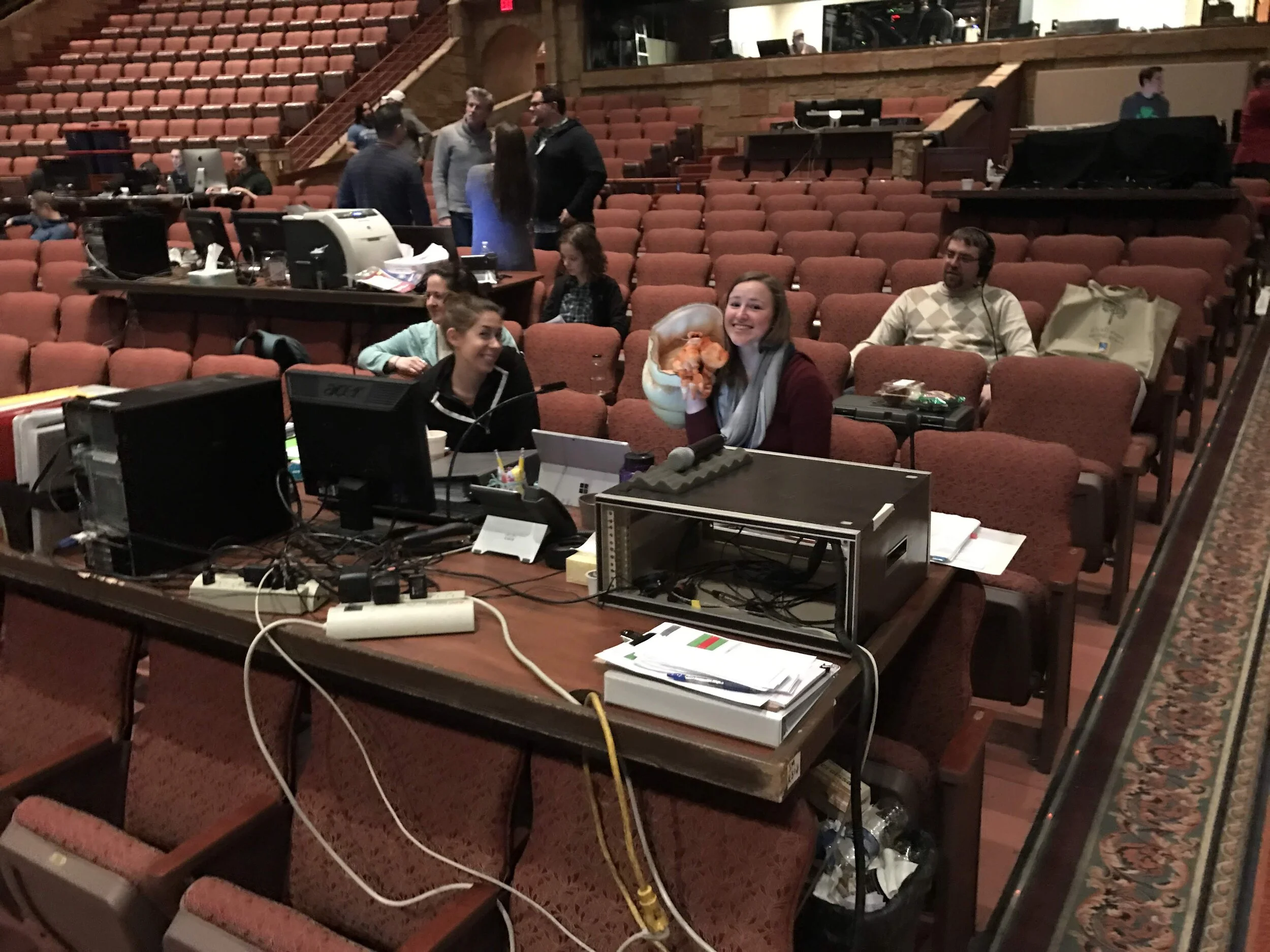 Lydia and Amberly (plus a hermit crab puppet ;), two members of the invincible Stage Management Team. There are several temporary tables set up throughout the auditorium for computers and things of that sort. They'll be removed when the show run beg…