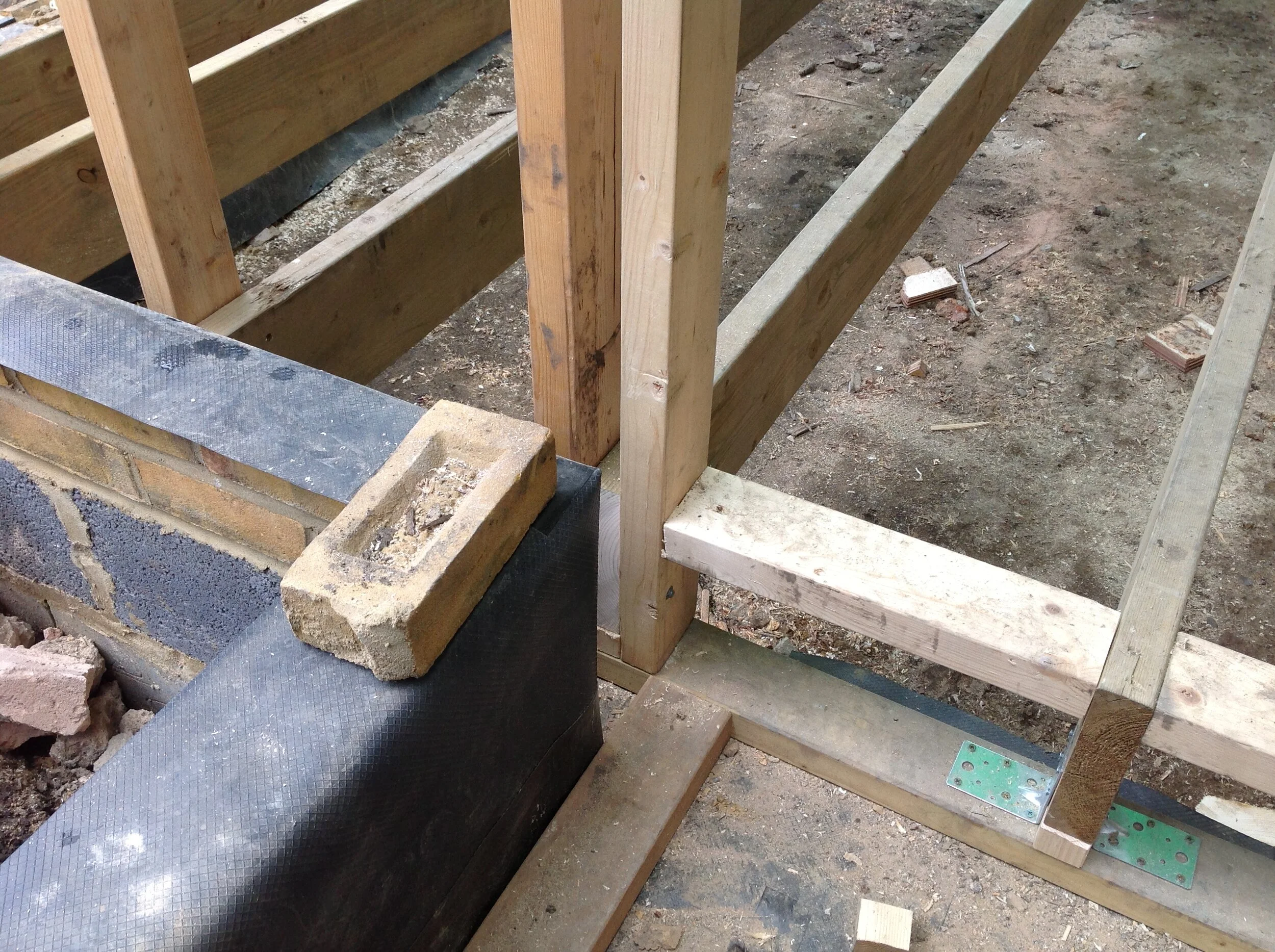 the damp proof course is 2 bricks above ground externally and runs down the inside of the plinth and under the sole plate which is sitting on concrete block, this enables the hempcrete to insulate the plinth