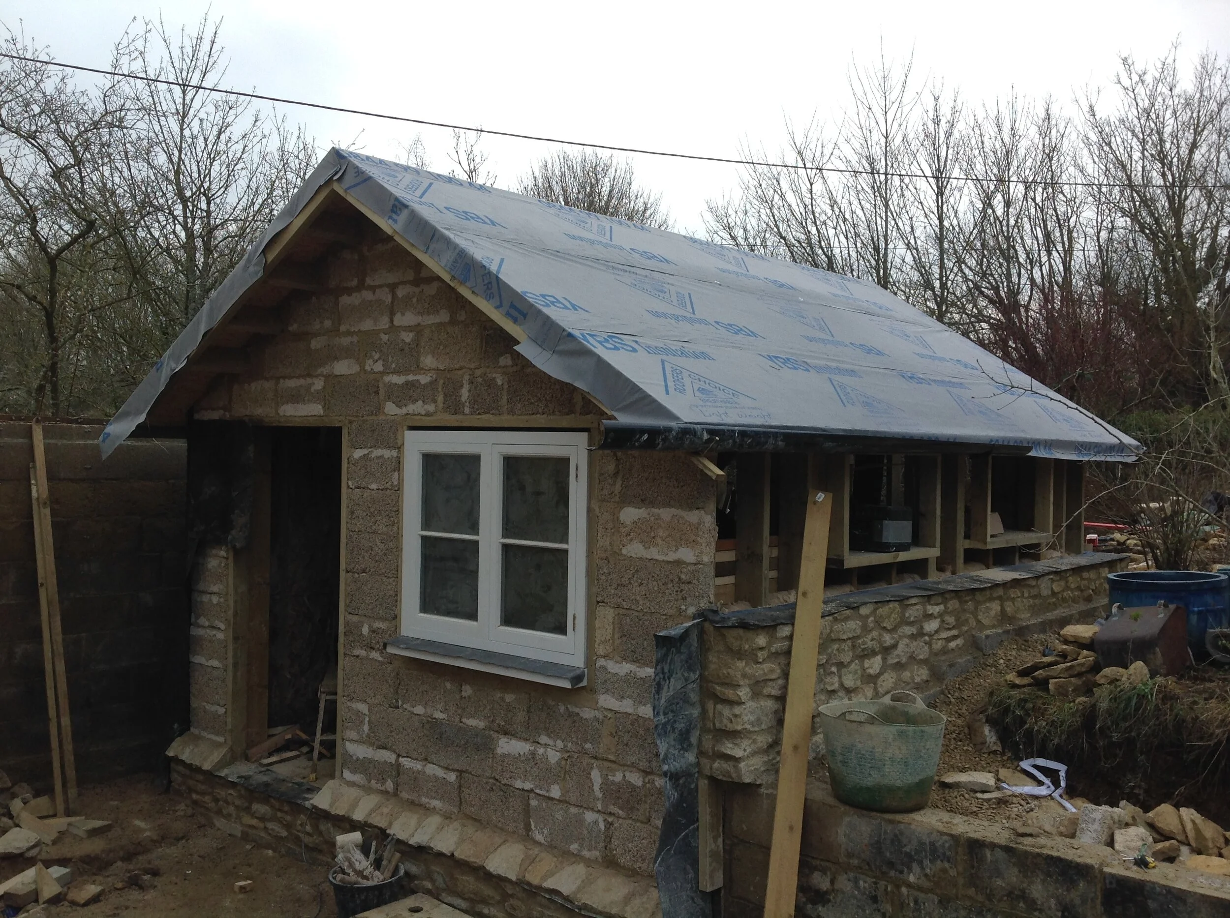 The boiler house is wooden box sunken into the ground wrapped in damp proof membrane and insulated with hempcrete blocks.