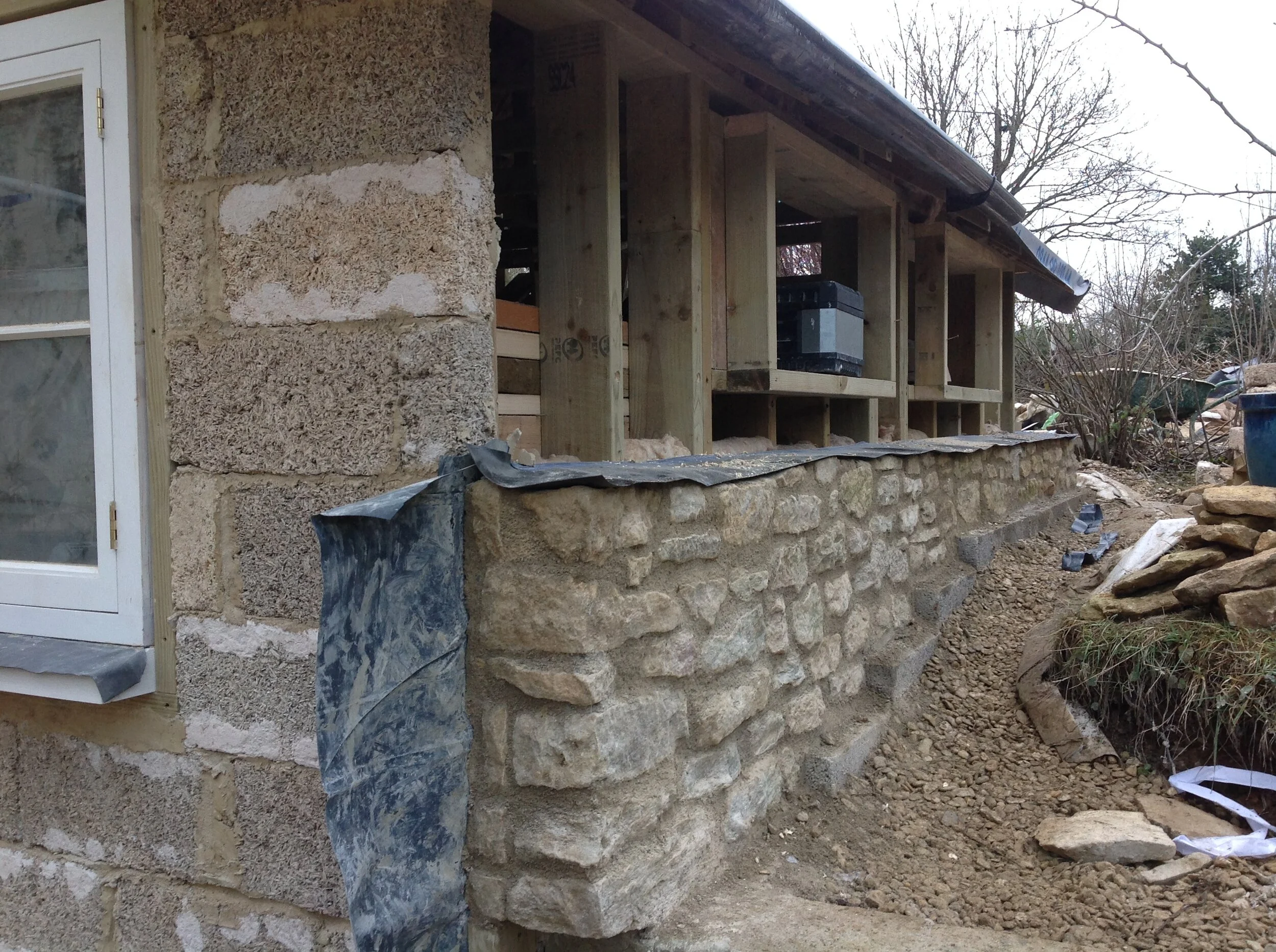 That damp proof membrane continues right under the boiler house and up the other side. The stiff box structure resists pressure from the soil on either side.