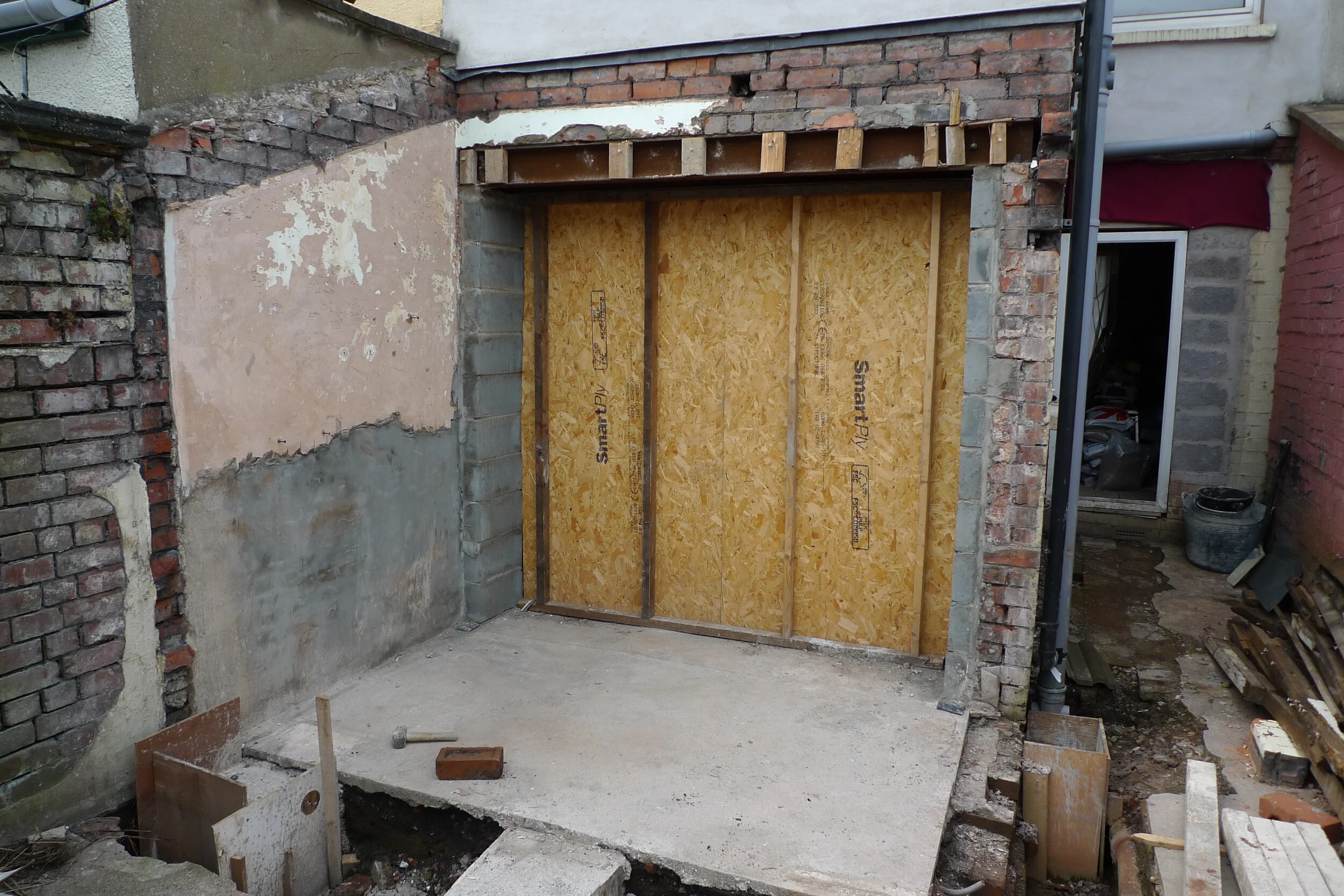 There had been an existing extension and its slab was retained. The foundations were concrete pads with concrete lintels bridging from pad to pad to reduce digging and reduce the amount of concrete.