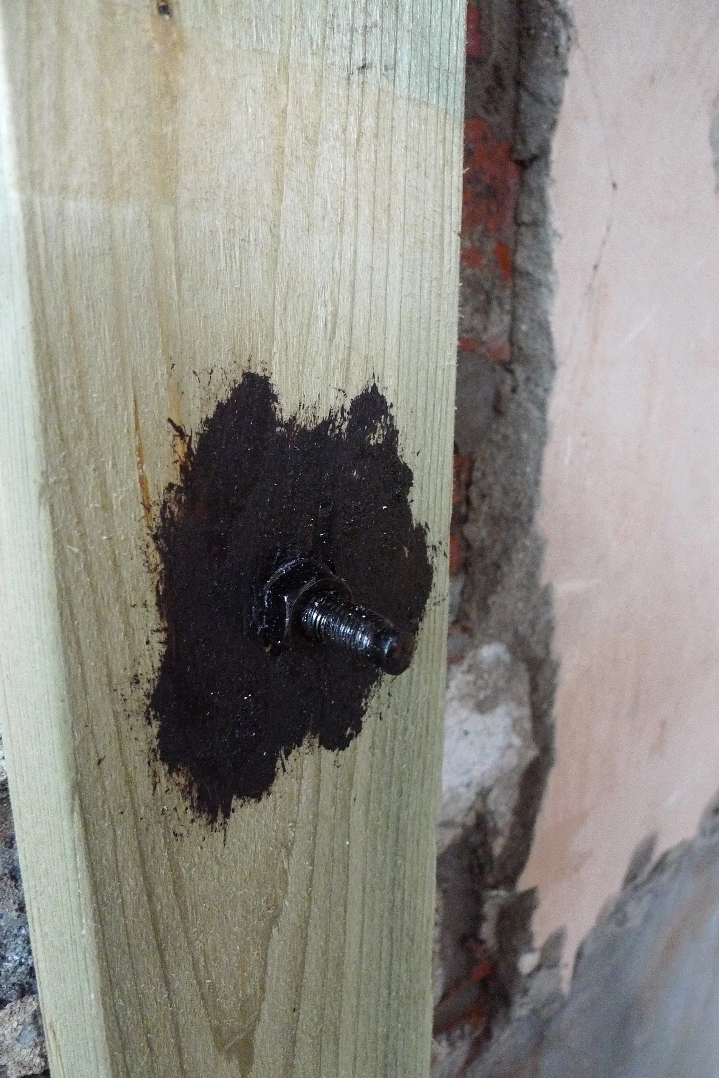 The threaded bar anchoring the frame to the house was not stainless steel so it was painted instead to protect it from the lime. 