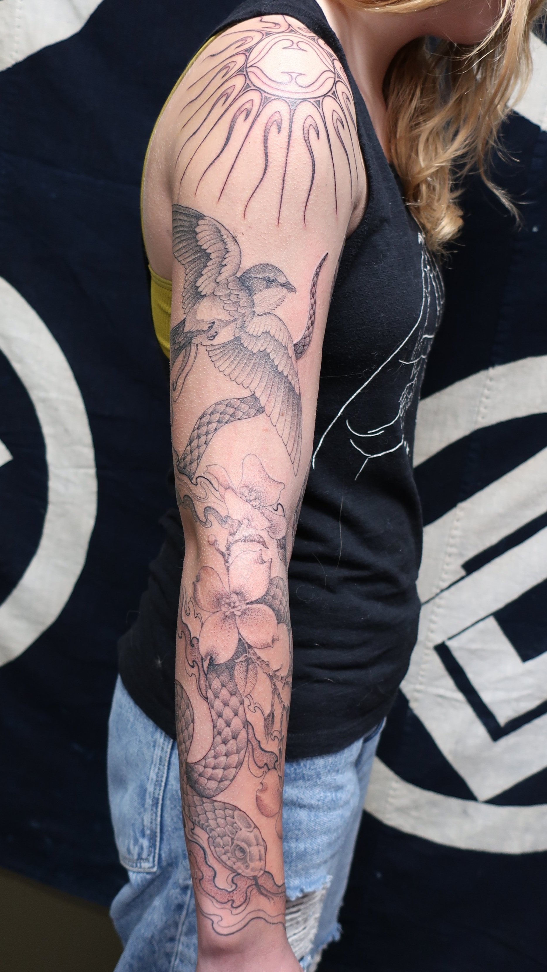 Women's fine line tattoo sleeve with bird and snake