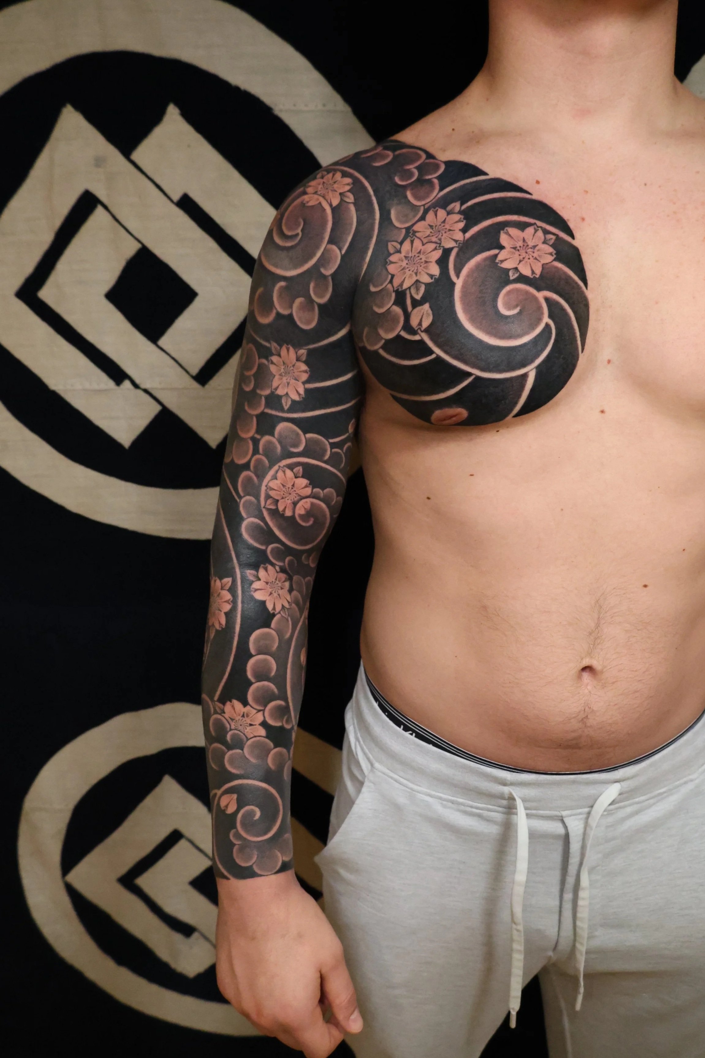 Irezumi Blackwork Japanese Tattoo Sleeve featuring clouds, swirls, wind bars, and cherry blossoms