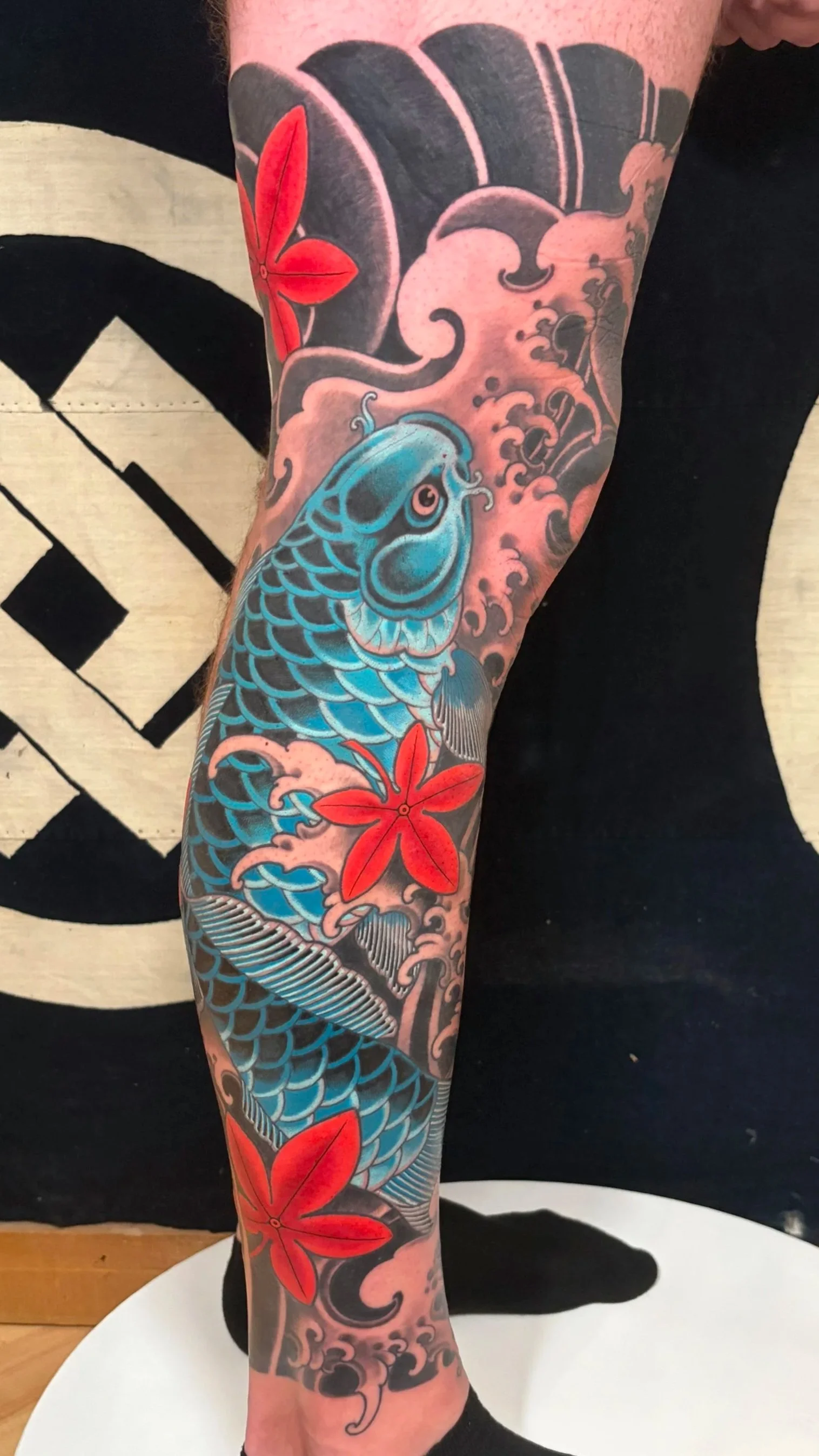Detailed Blue Koi Japanese Inspired leg sleeve with black and grey water, wind bars background