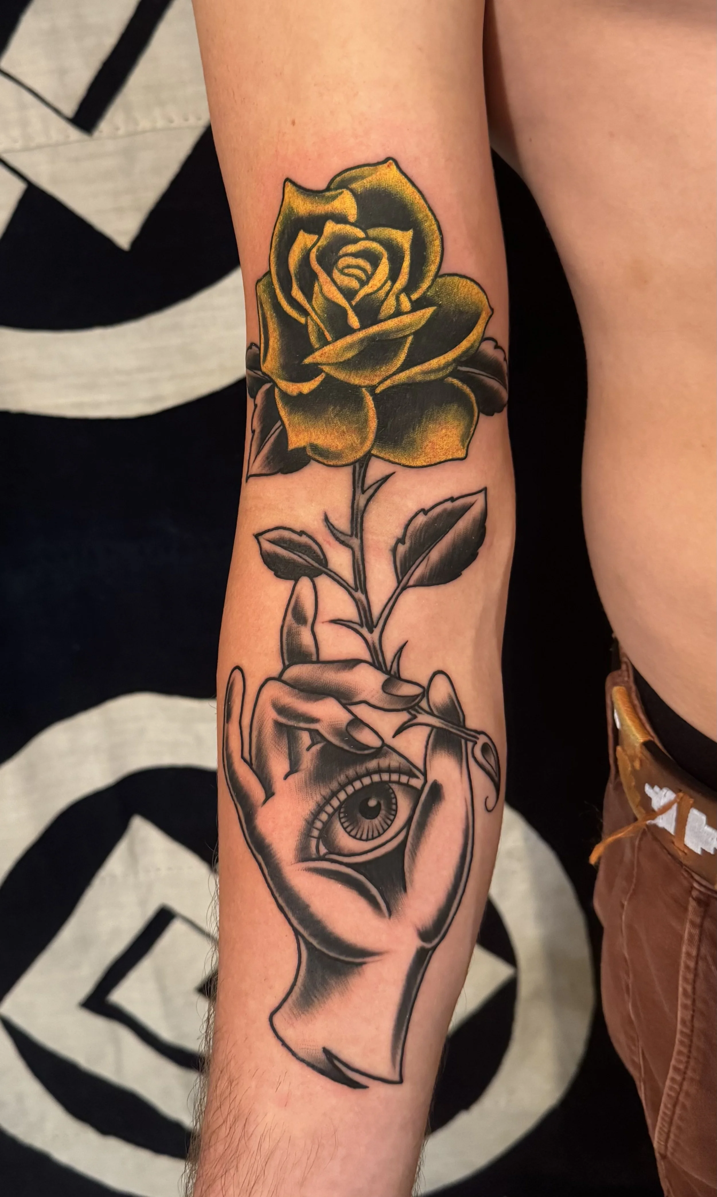 Custom Freehand Hamsa and evil eye forearm tattoo with yellow rose