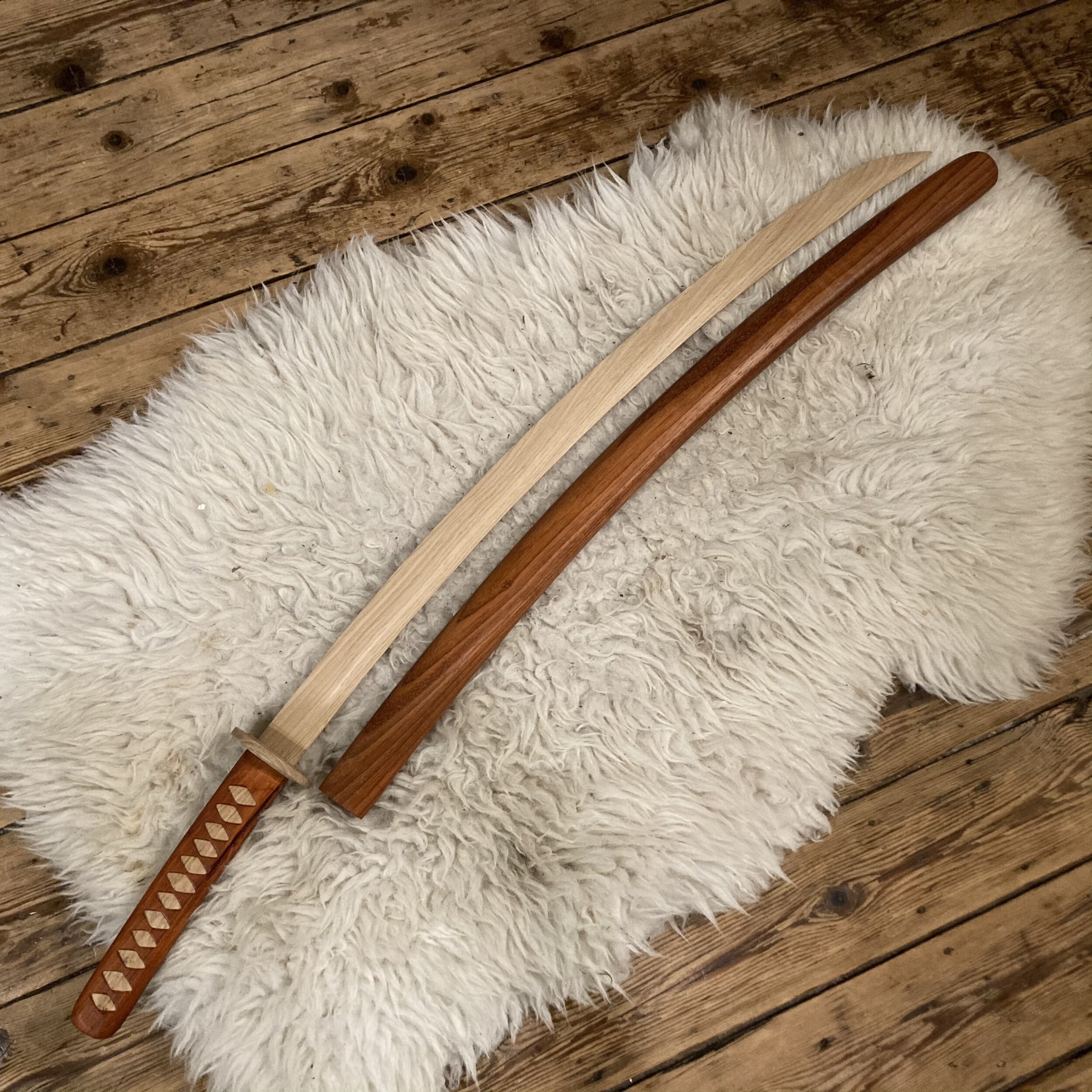 Sword, unsheathed. Still cosy on some furs.