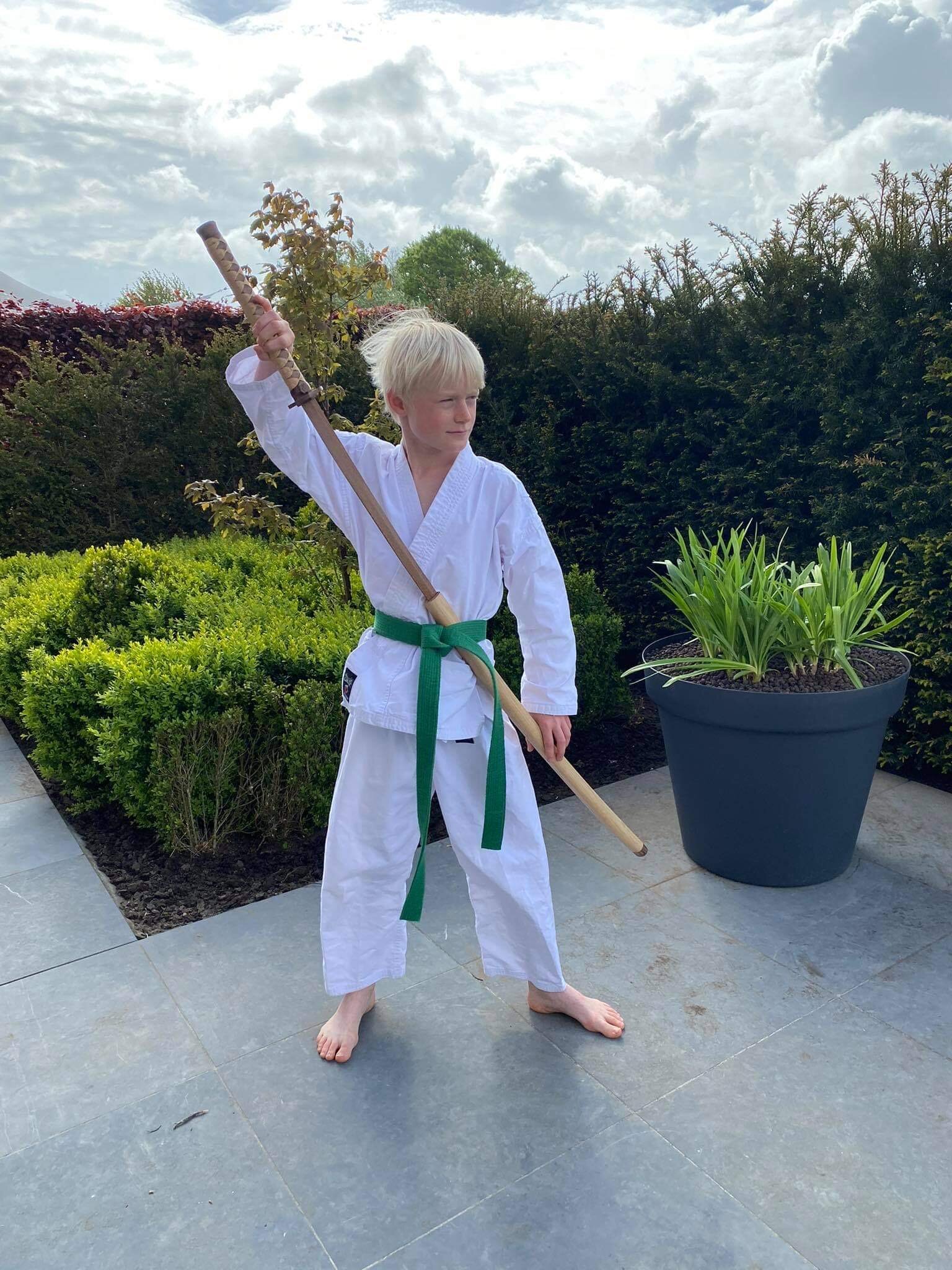 A boy and his sword. This sword was built as a birthday gift from his parents. (Obviously these people have great taste). I was told he was all about Karate, so... I themed this katana around that.