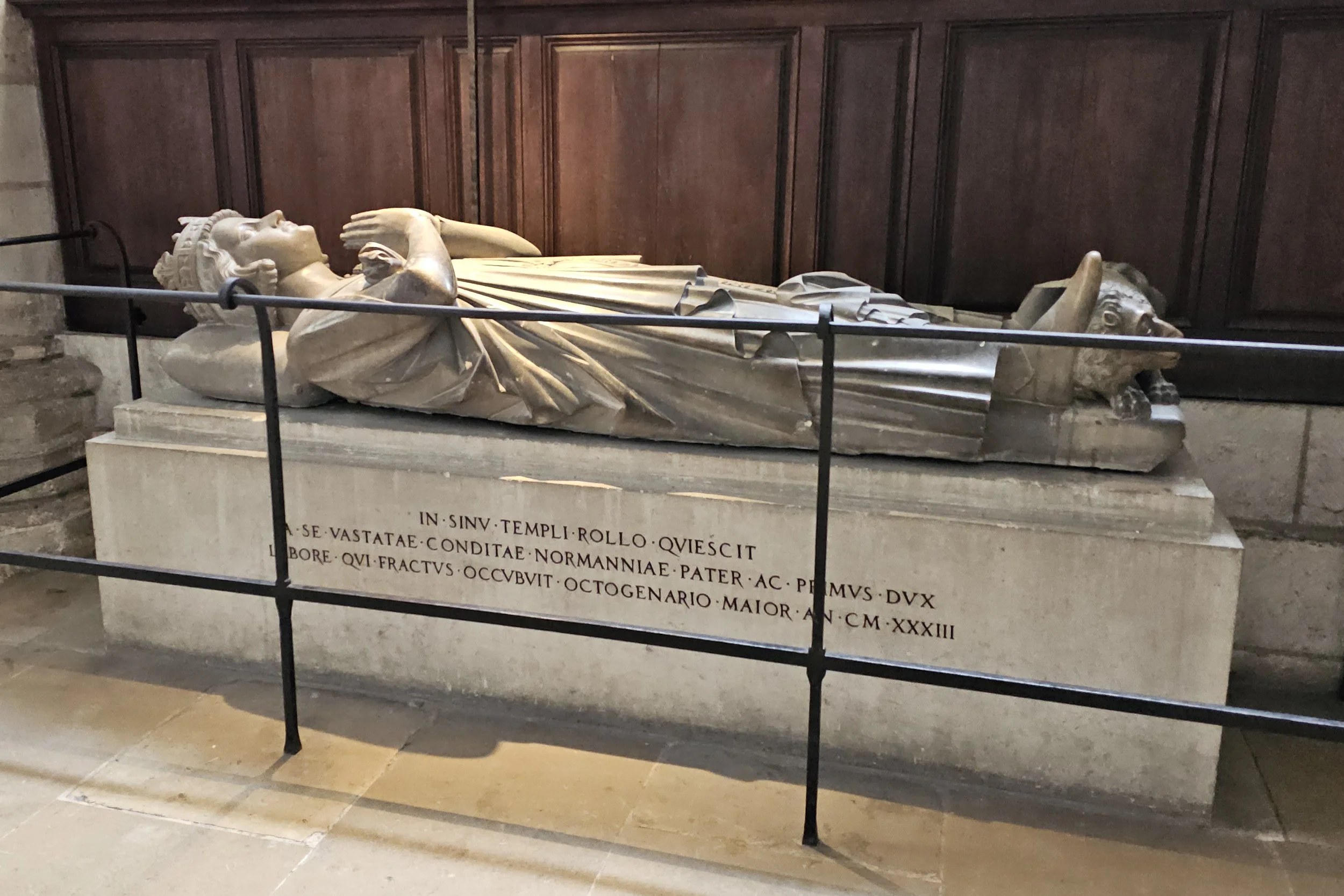 Tomb of Rollo, first ruler of Normandy, inside Rouen Cathedral, with his recumbent effigy resting beneath a stone arch.
