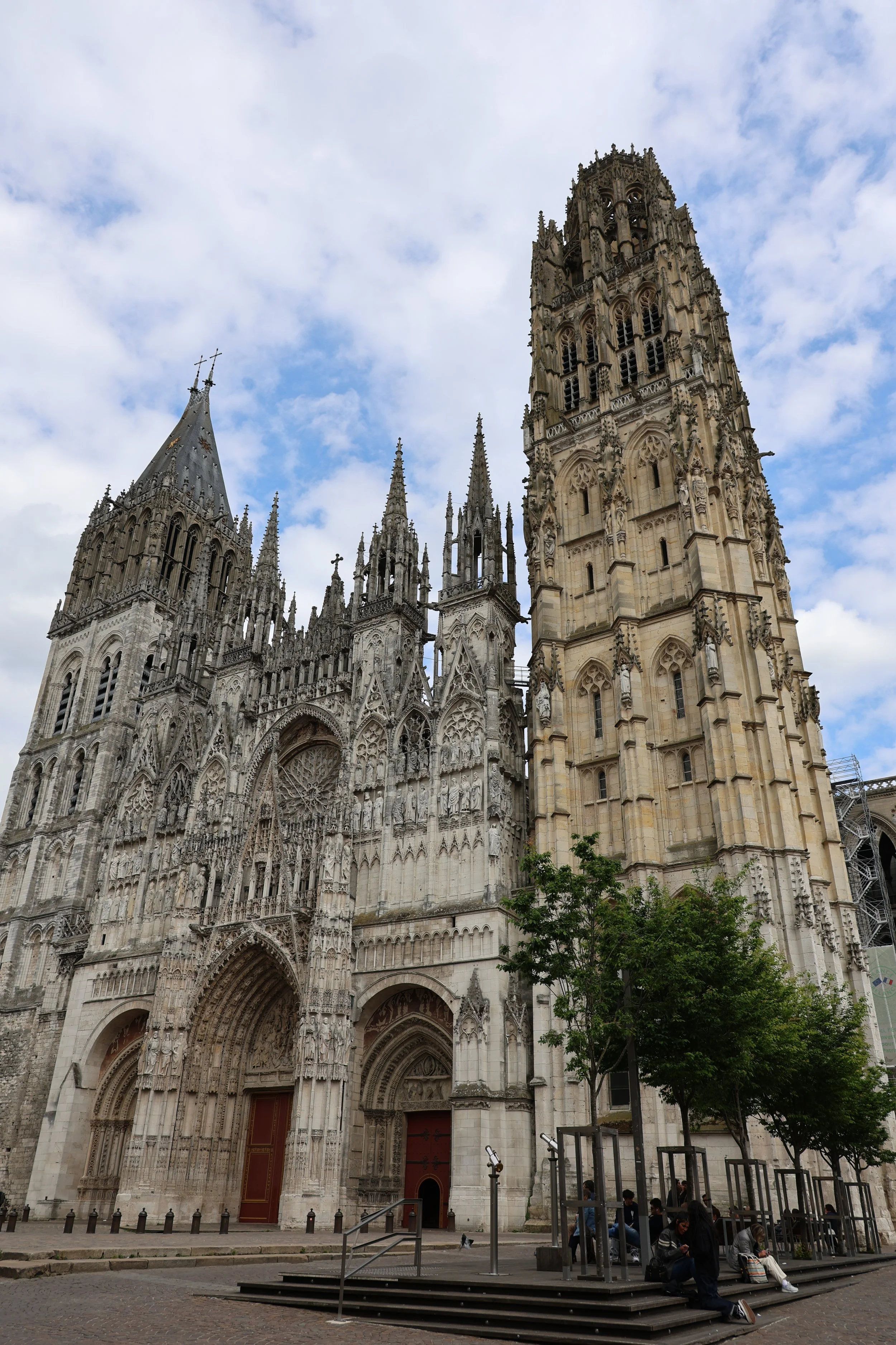 West façade of Rouen Cathedral in Normandy, showing its ornate Gothic architecture, twin towers and soaring central spire.
