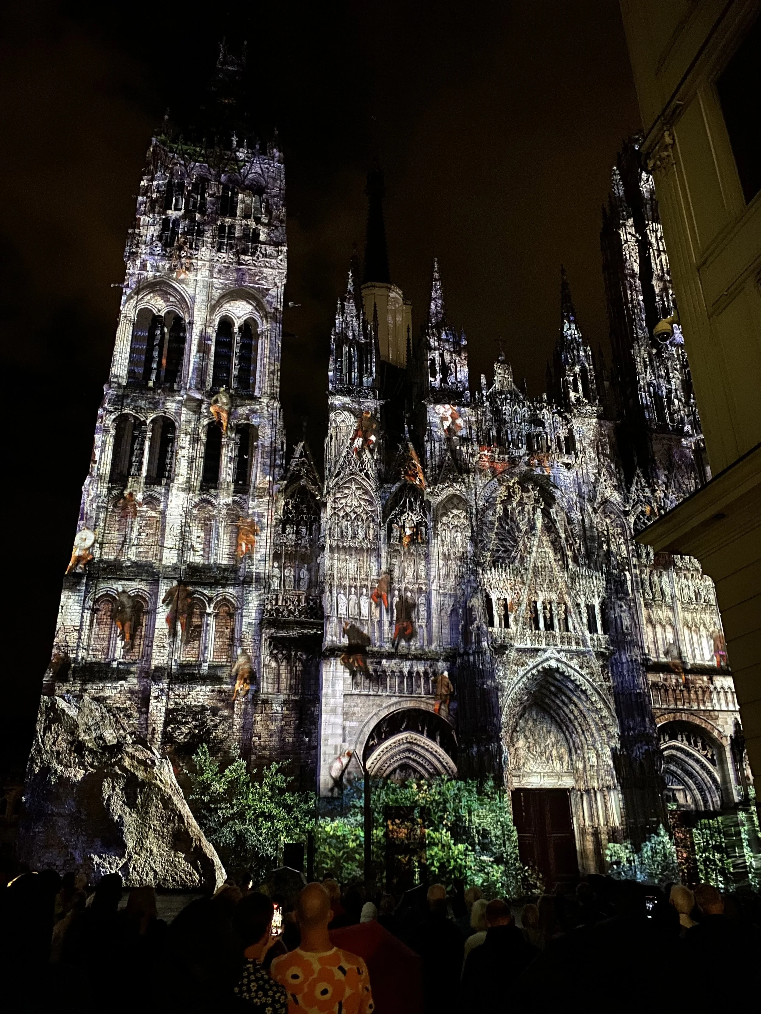 Rouen Cathedral illuminated during the 2022 light show, with figures projected across the Gothic façade as part of a visual history of Normandy.
