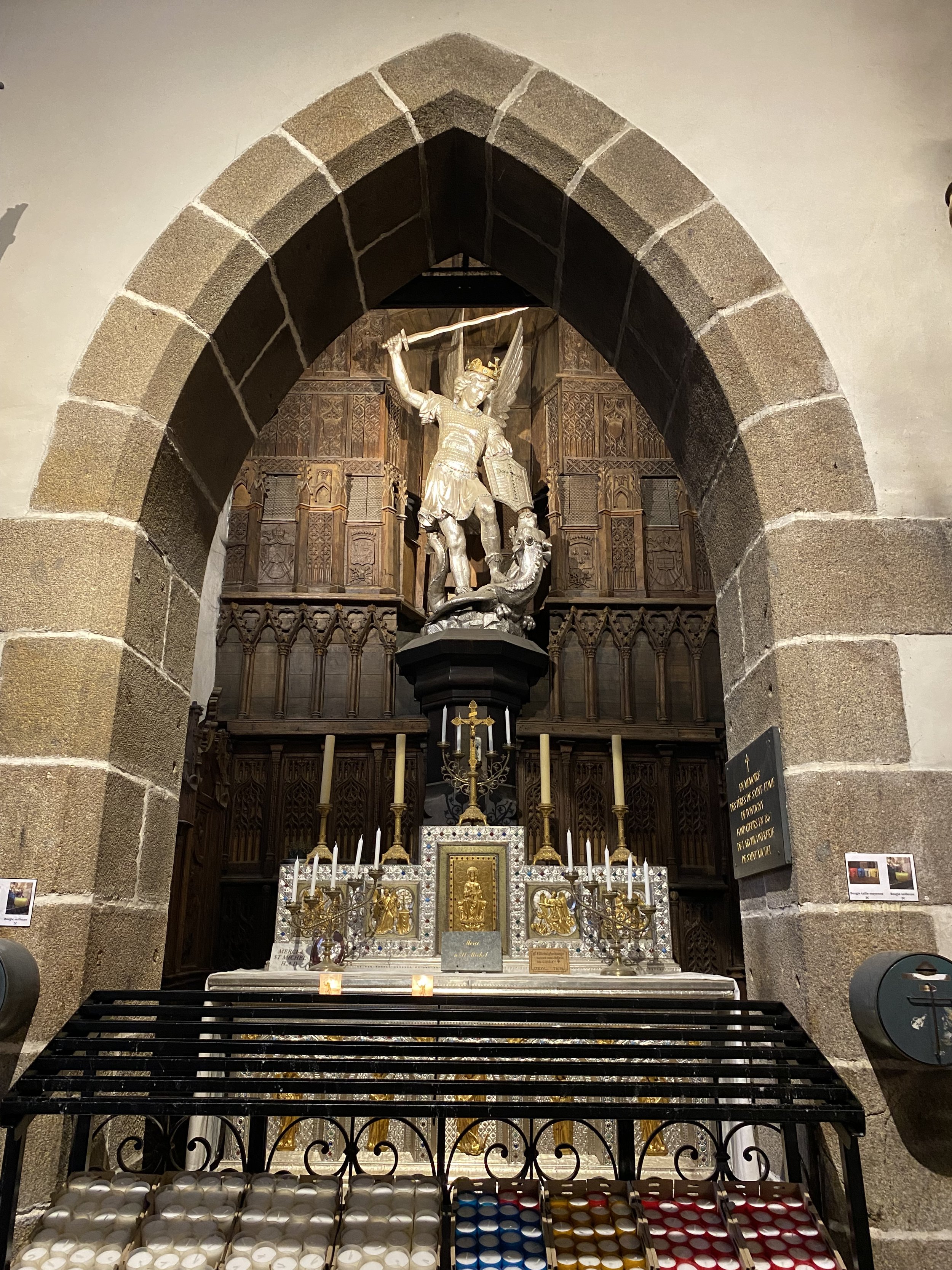 Statue of Saint Michael defeating the dragon above the altar inside Église Saint-Pierre on Mont Saint-Michel in Normandy.