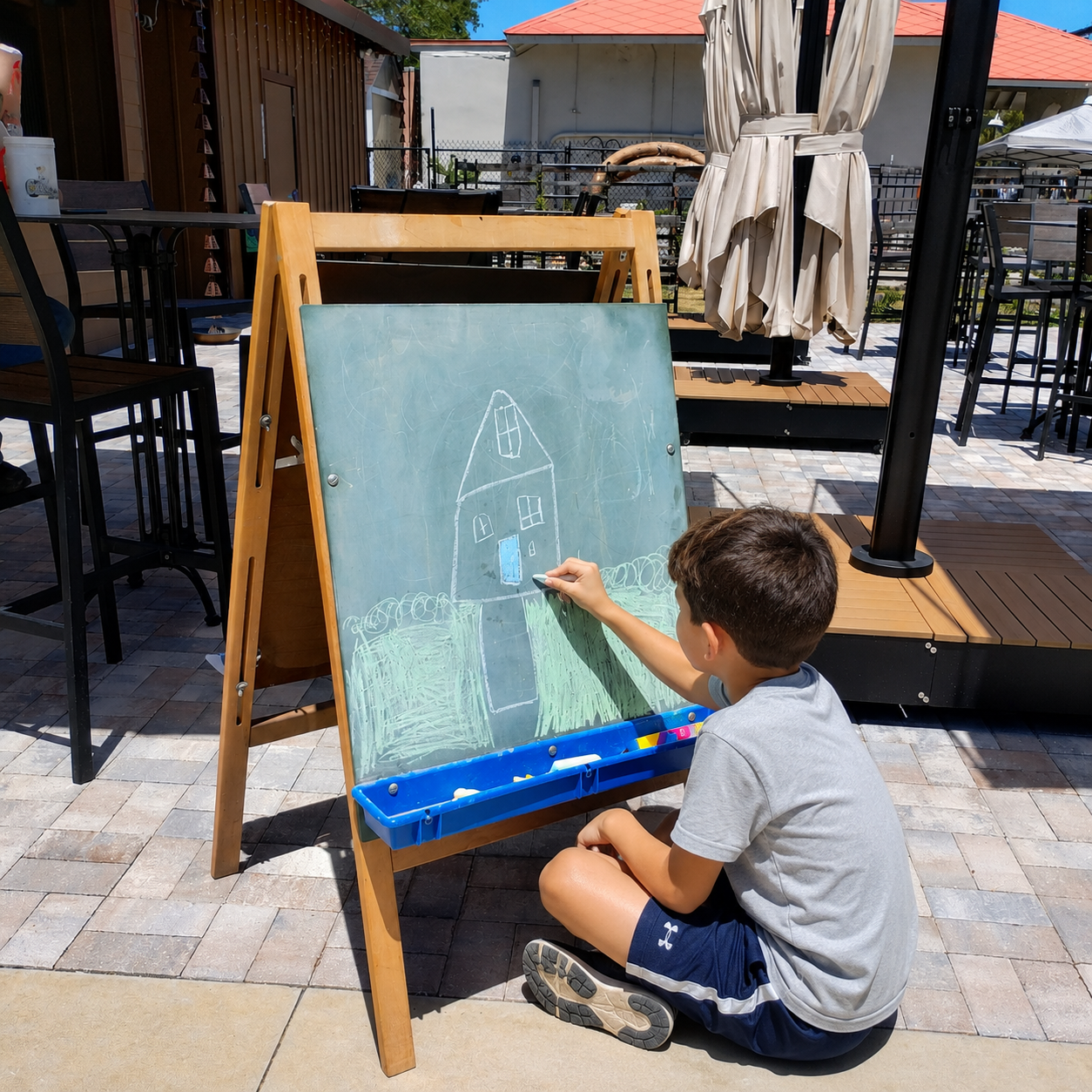 Kid drawing on chalk board.png