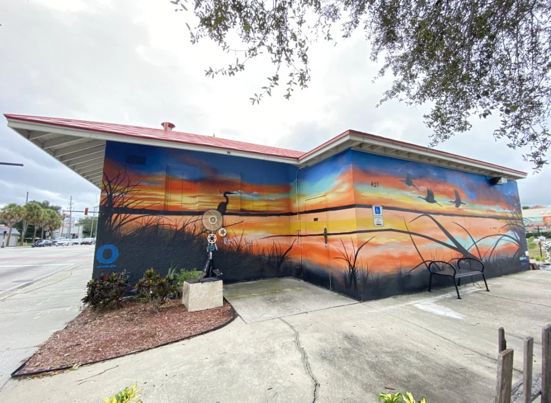 An Image of the Toho Mural on Broadway, Kissimmee Florida. Depicts a Toho Lake sunrise.