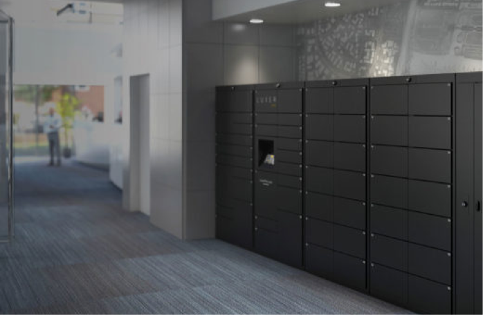 Black indoor Luxer One lockers along an office corridor