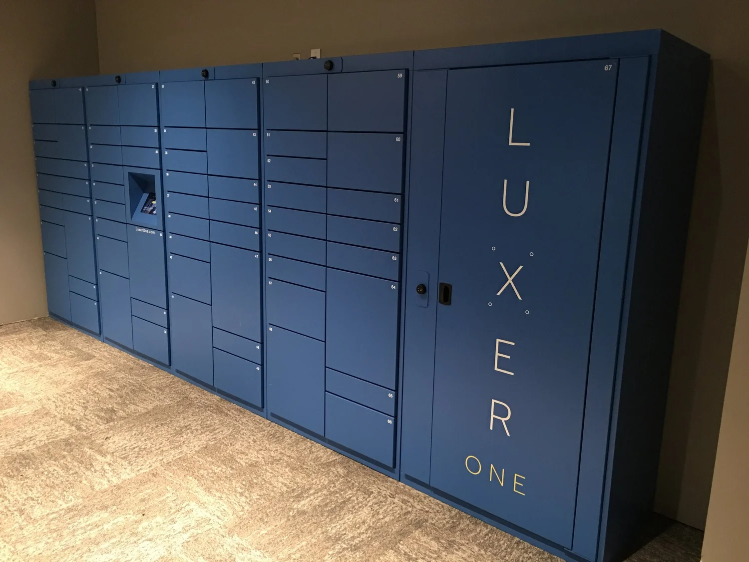 A long bank of Luxer One lockers finished in a custom blue